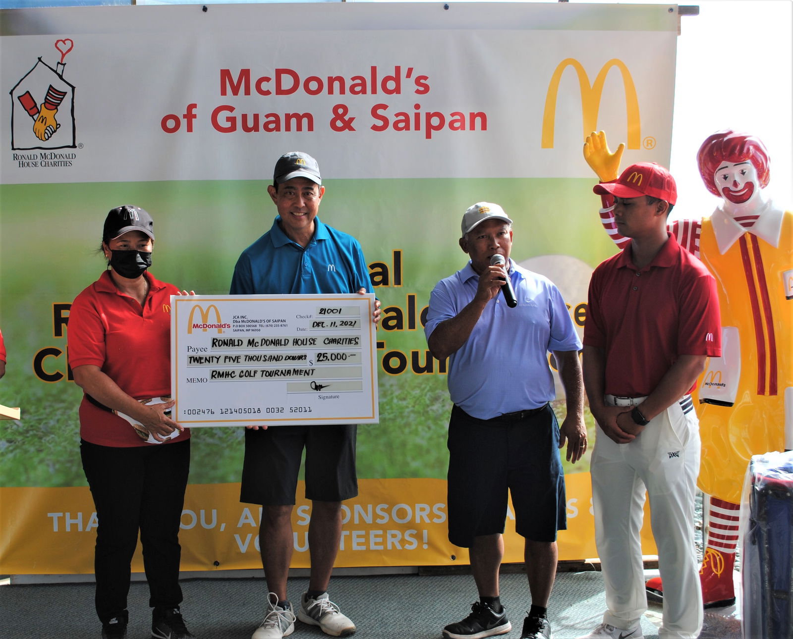 McDonald's Saipan & Guam's co-owners Marcia Ayuyu and Joe Ayuyu Sr. with their son Joe Jr. present a ceremonial check for $25,000 to Brian Wong who will donate it to the Ronald McDonald House of Charities. The amount was raised through the golf tournament hosted by McDonald’s Saipan & Guam on Saturday at Laolao Bay Golf & Resort.