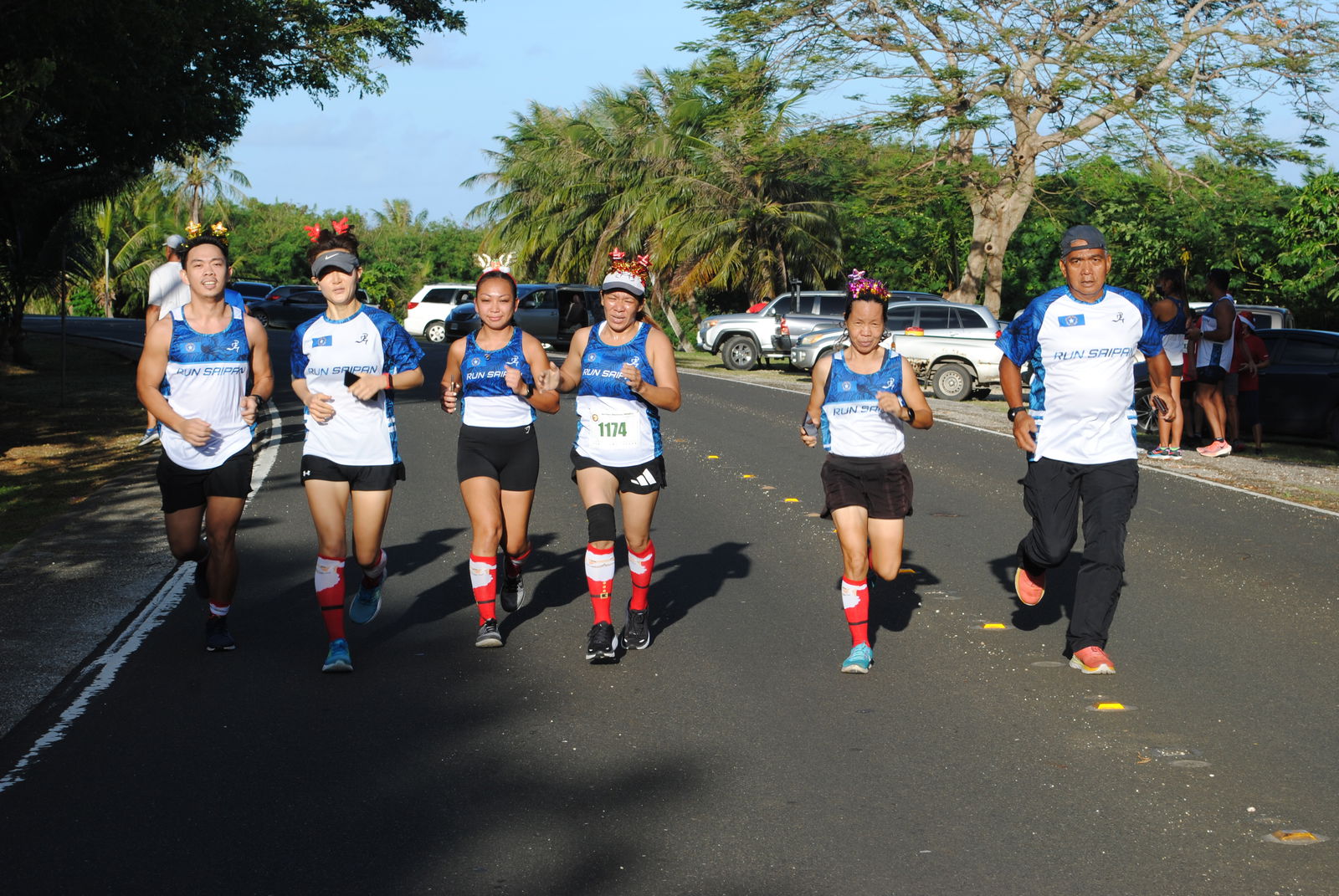 The Run Saipan Team 2 members push through as they approach the finish line.