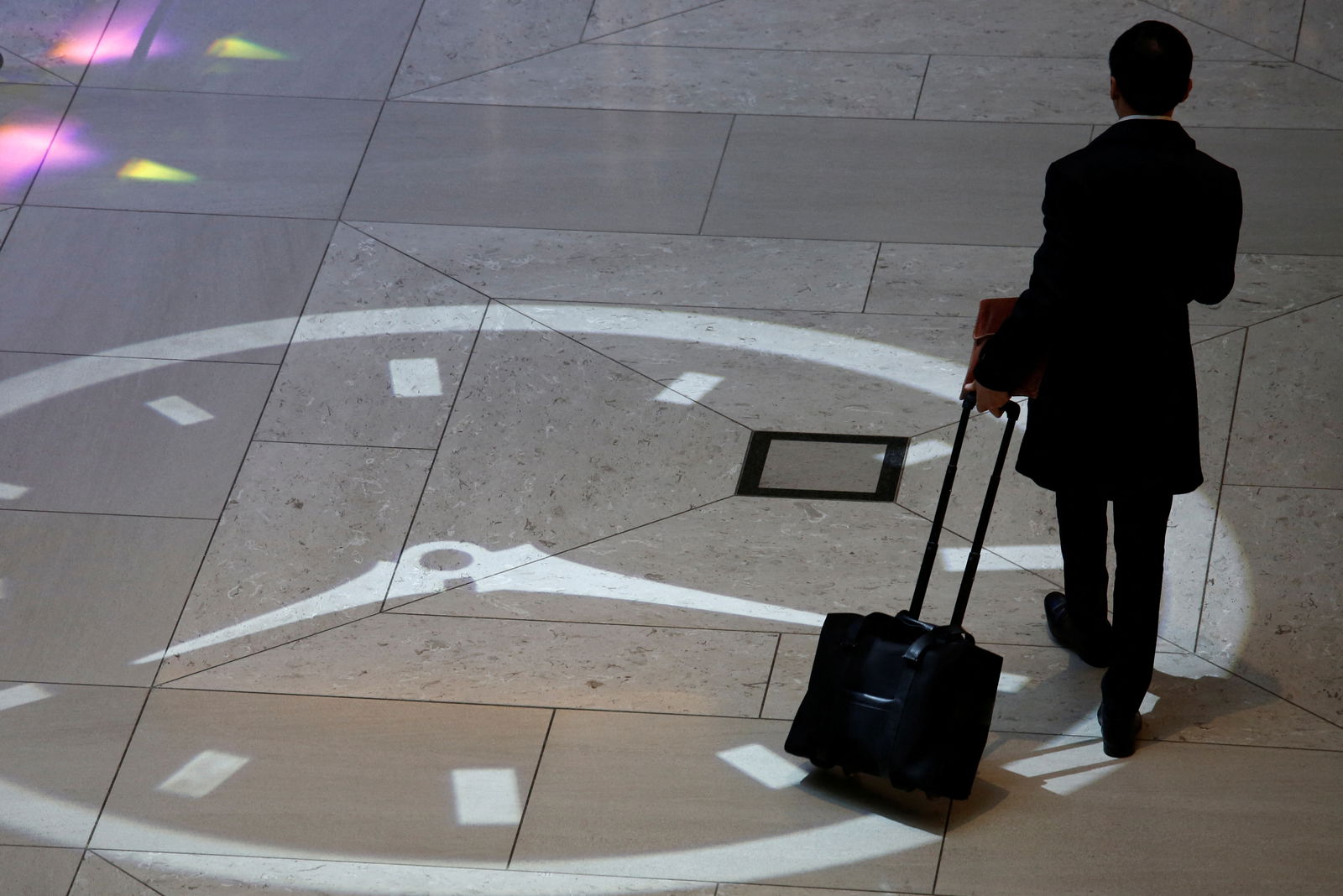 A man walks inside the mall of a commercial tower at the financial Central district in Hong Kong on Nov. 23, 2017.