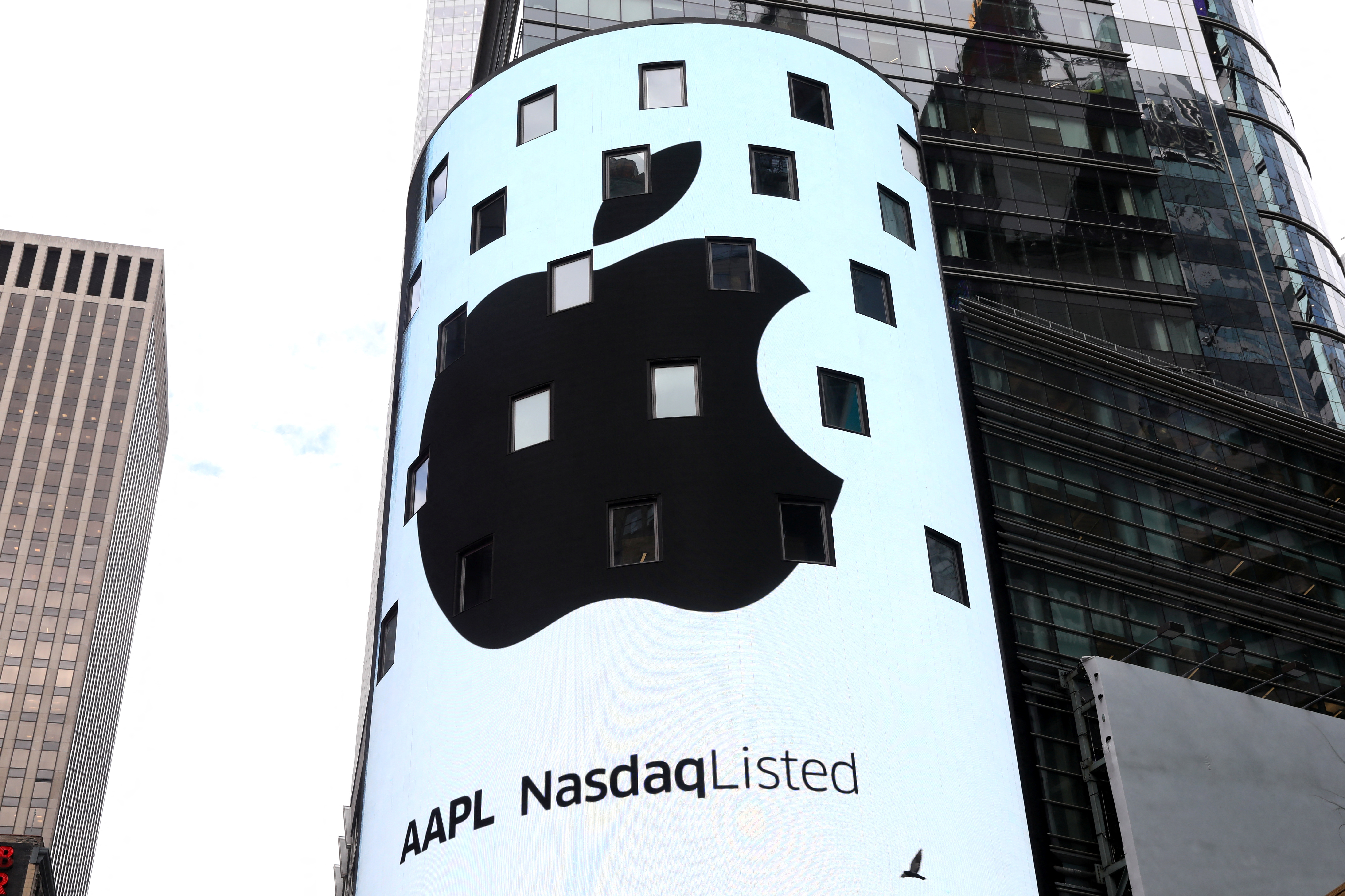 An electronic screen displays the Apple Inc. logo on the exterior of the Nasdaq Market Site following the close of the day's trading session in New York City, Aug. 2, 2018.