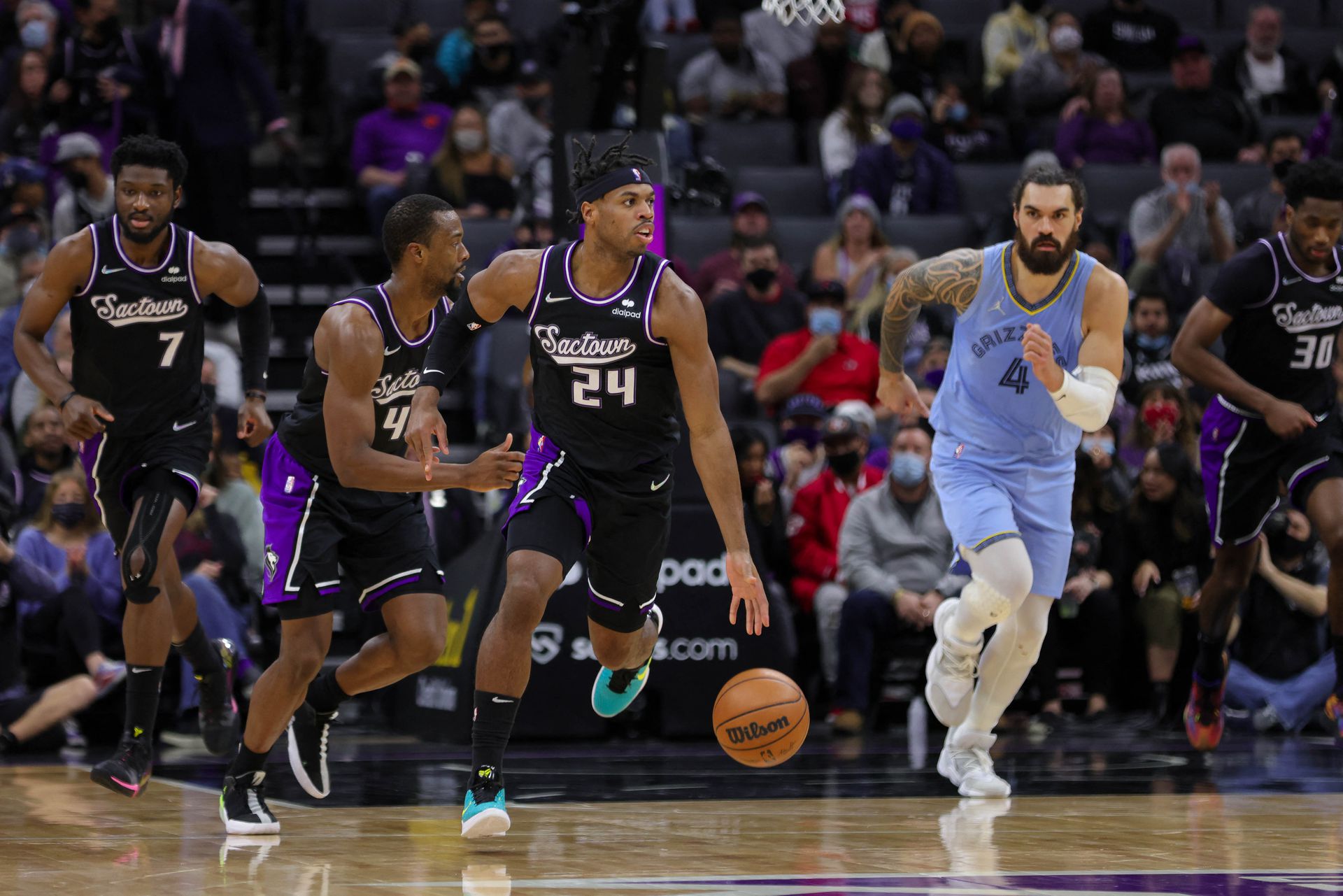 Sacramento Kings guard Buddy Hield (24) dribbles the ball up the court past Memphis Grizzlies center Steven Adams (4) during the second quarter at Golden 1 Center in Sacramento, California on Dec. 26, 2021.