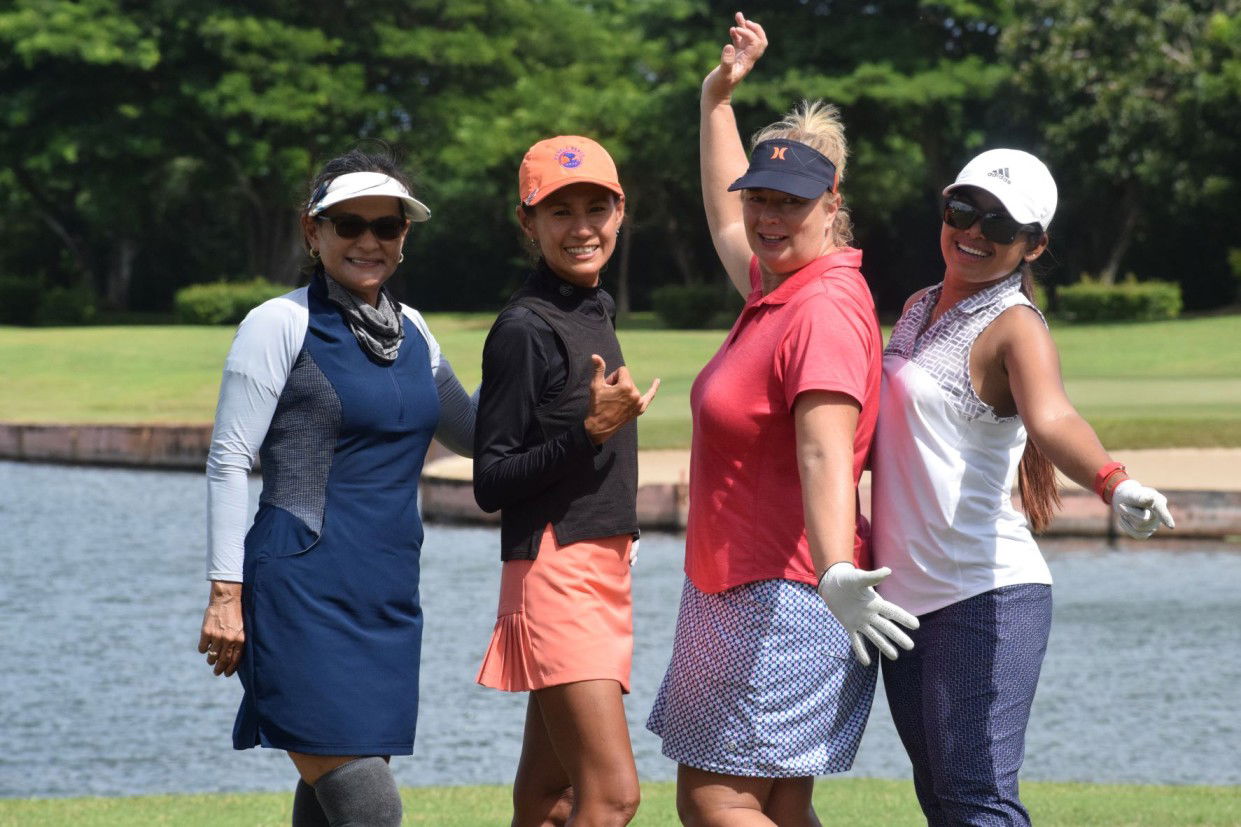 Ladies Flight players Terry Guerrero, Lydia Tan, Paula Stewart and Ary Hallmark pose after teeing off for Hole No. 14.