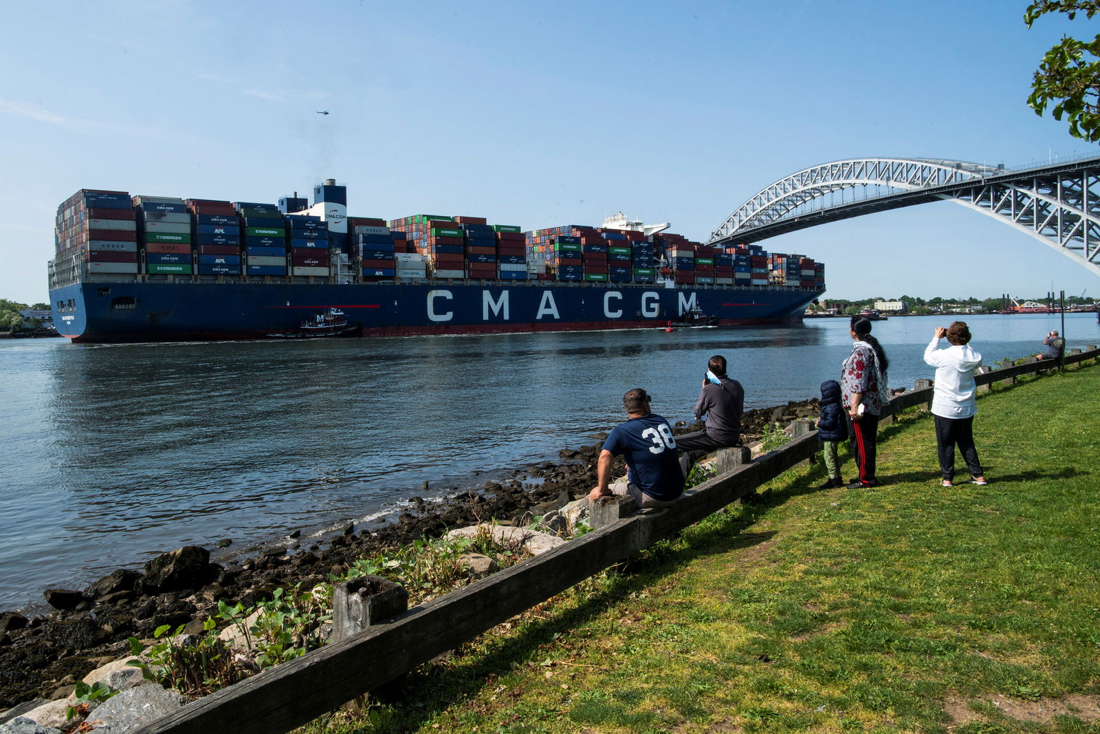 People take a look at the CMA CGM Marco Polo, an Explorer class container ship entering Newark bay to dock in Elizabeth port as seen from Bayonne, New Jersey, May 20, 2021.