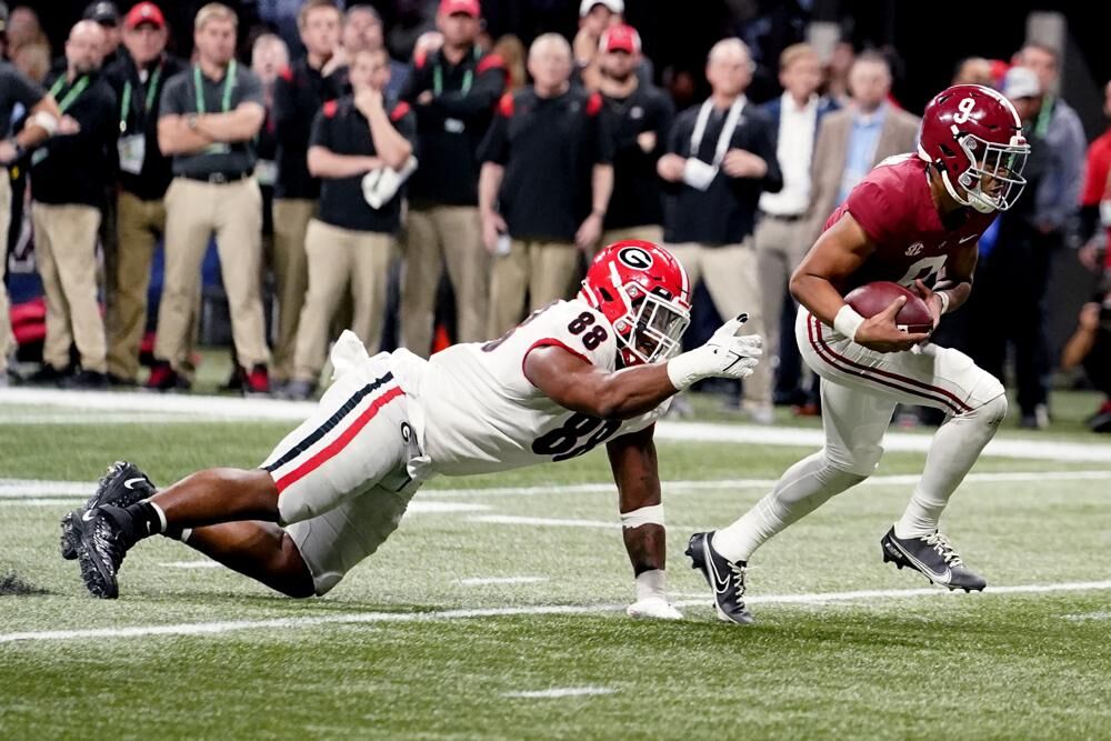 Alabama quarterback Bryce Young (9) run s past Georgia defensive lineman Jalen Carter (88) for a touchdown during the first half of the Southeastern Conference championship NCAA college football game, Saturday, in Atlanta.