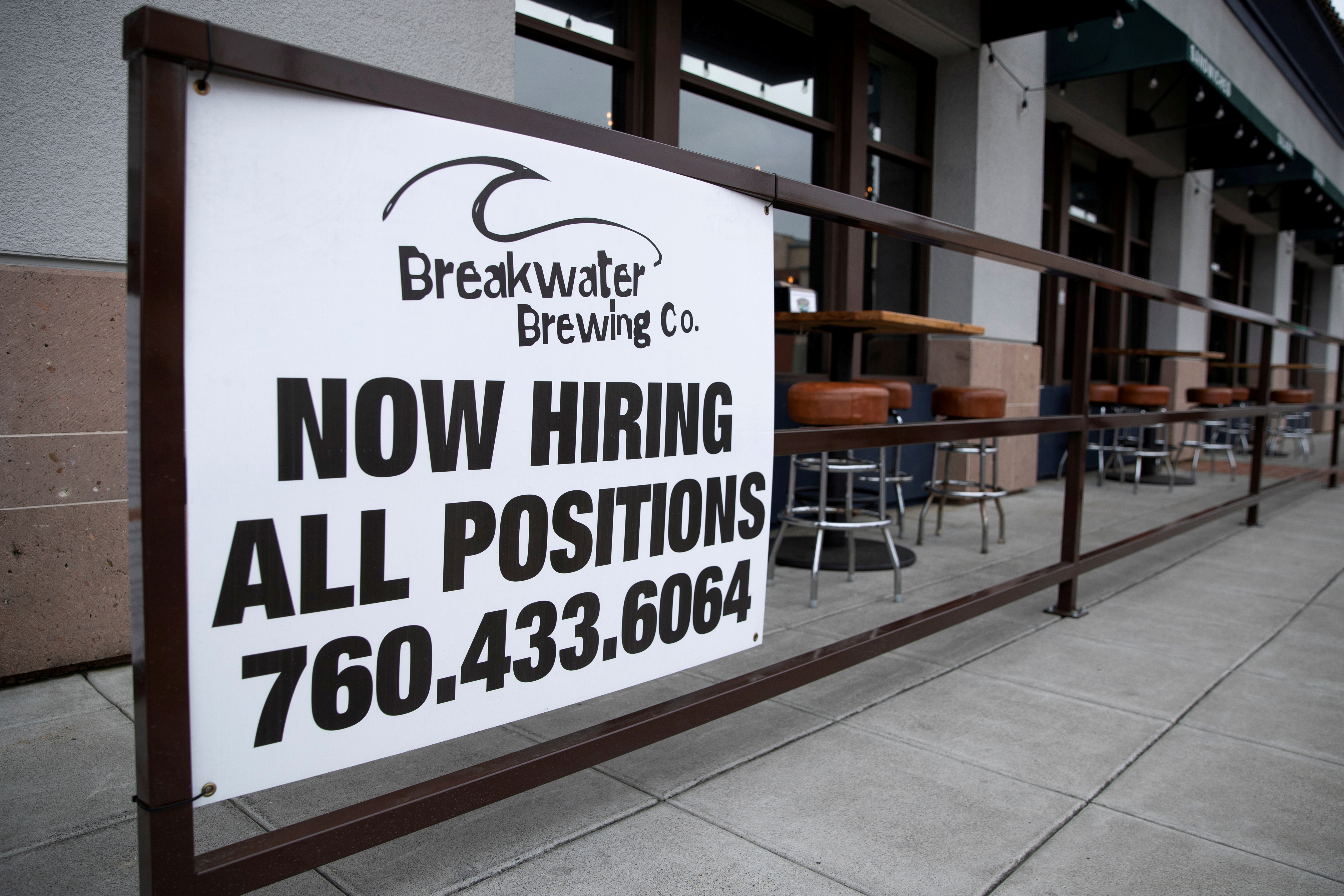 A restaurant advertising jobs looks to attract workers in Oceanside, California, May 10, 2021.