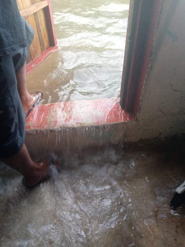 A man in Losap Island in the Upper Mortlocks section of Chuuk, Micronesia watches as ocean water rushes into his house.