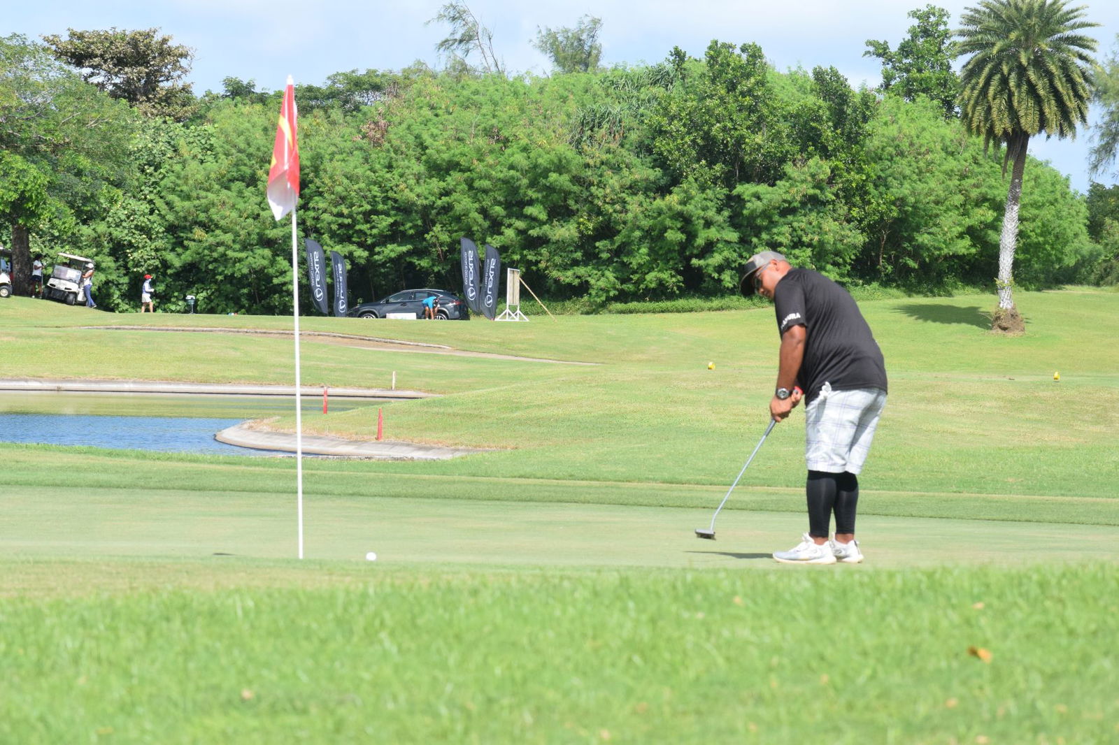 Harry Nakamura swings for a long putt on Hole No. 13.