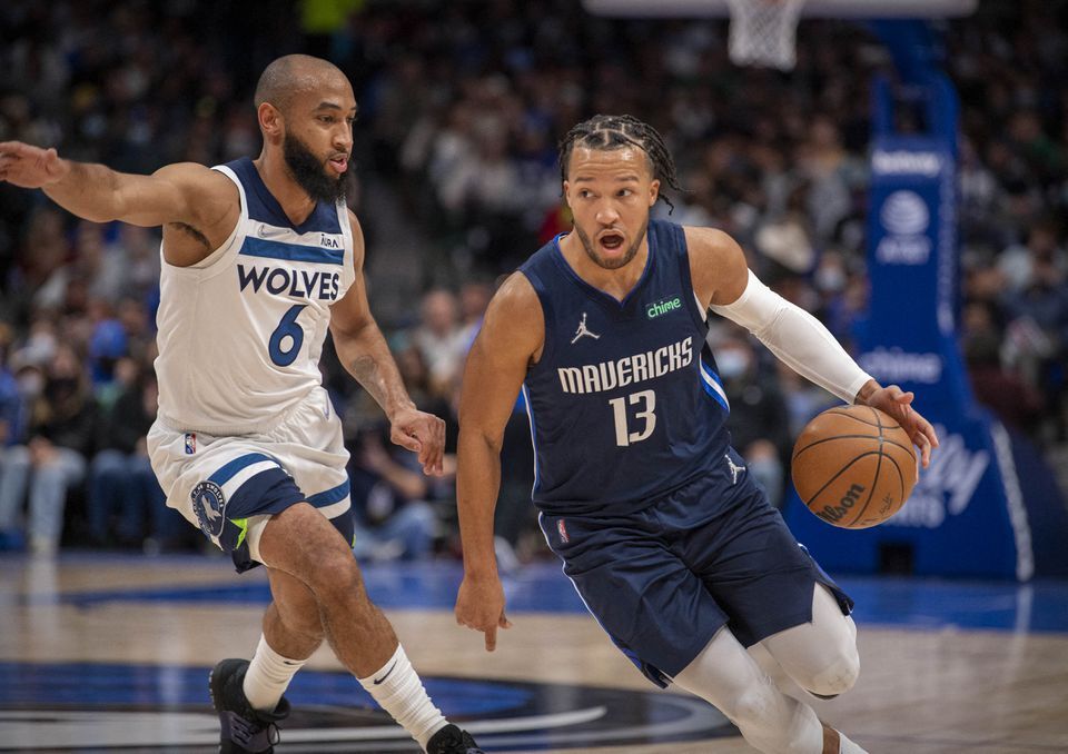 Dallas Mavericks guard Jalen Brunson (13) brings the ball up court past Minnesota Timberwolves guard Jordan McLaughlin (6) during the second quarter at the American Airlines Center in Dallas, Texas on Dec. 21, 2021.
