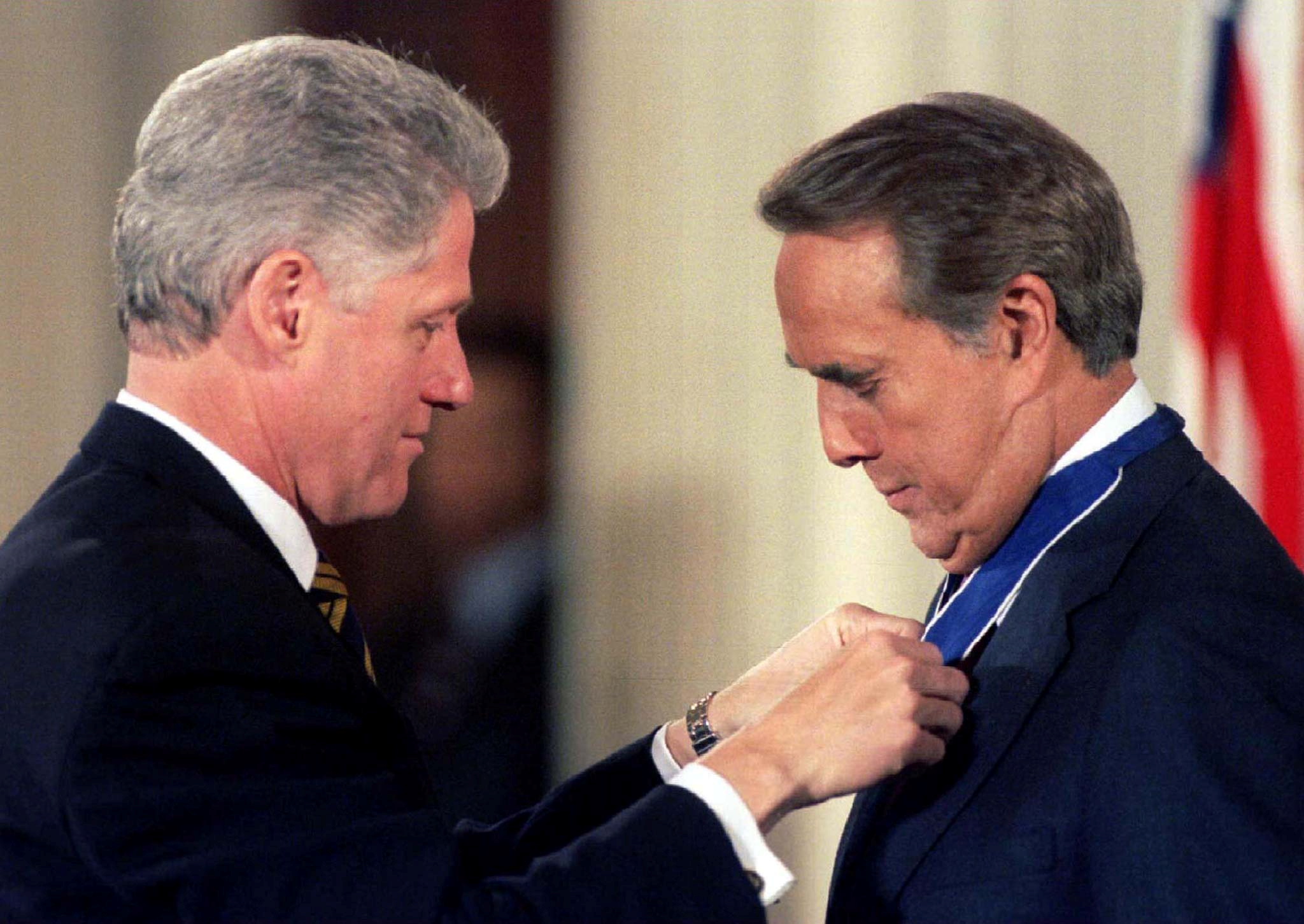 President Bill Clinton pins the Presidential Medal of Freedom, the nation's highest civilian award, on former Sen. Bob Dole, Jan. 17, 1997.