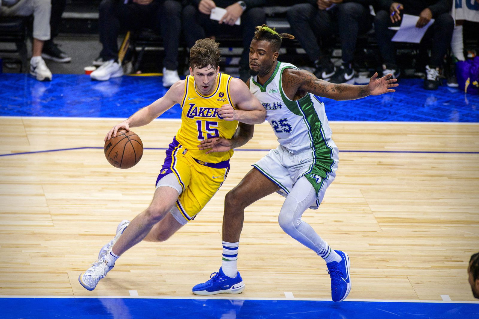 Dallas Mavericks forward Reggie Bullock (25) defends against Los Angeles Lakers guard Austin Reaves (15) during the first half at the American Airlines Center Dallas, Texas on Dec. 15, 2021.