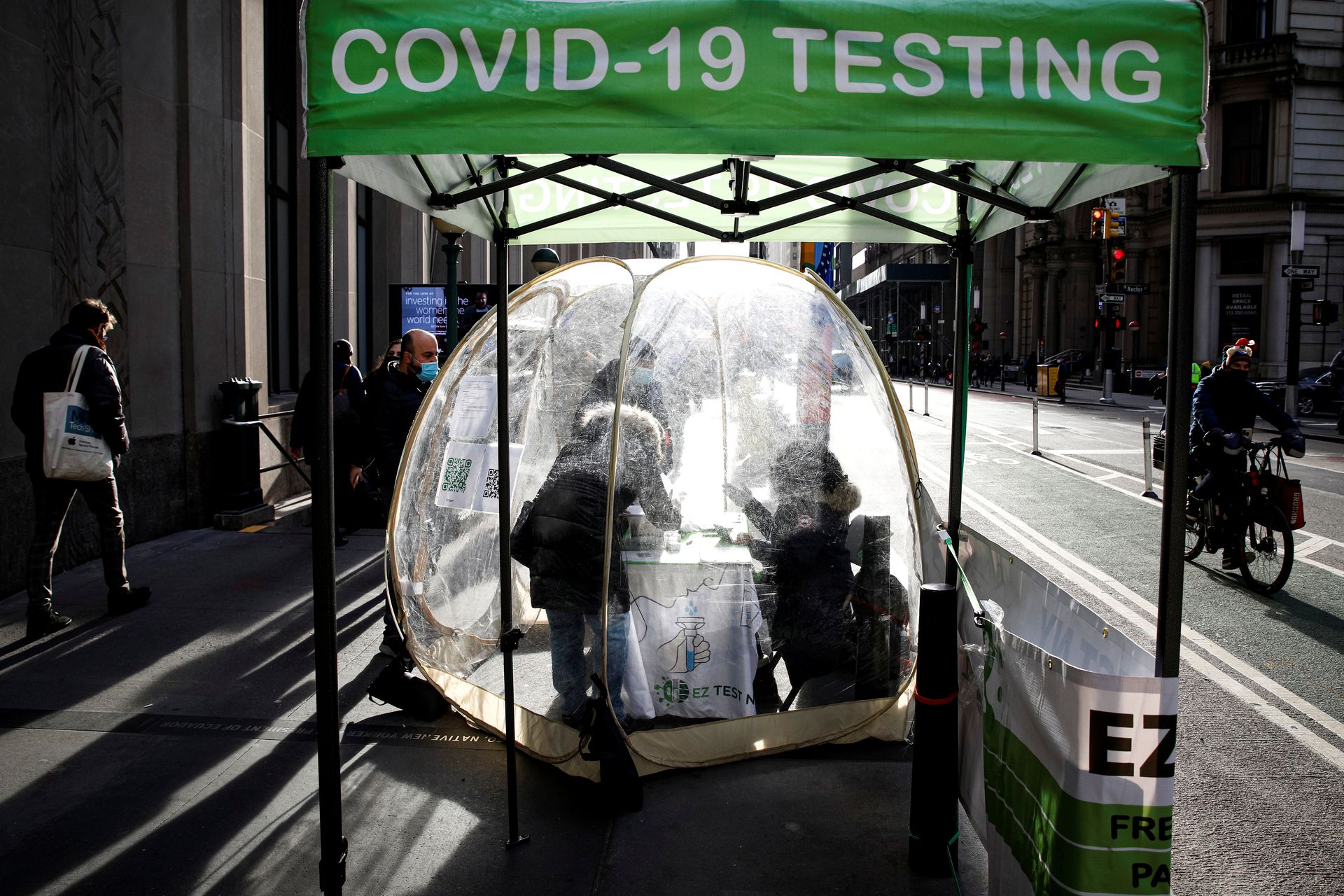 People take coronavirus disease tests at a pop-up sidewalk testing site in New York, Dec. 1, 2021.