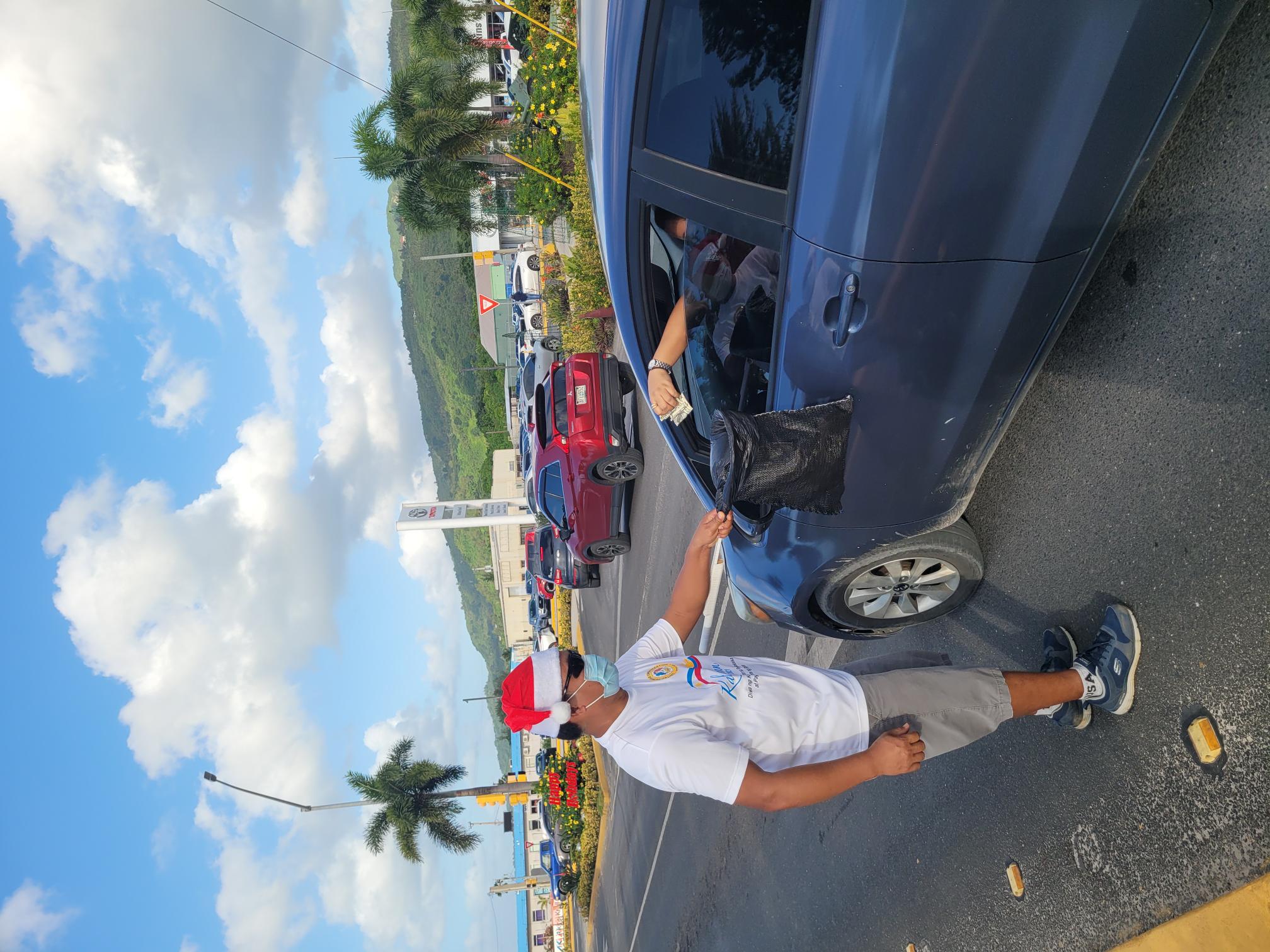 United Filipino Organization president Mar Masilungan receives a cash donation from a motorist at the San Jose/Oleai traffic intersection on Friday afternoon.