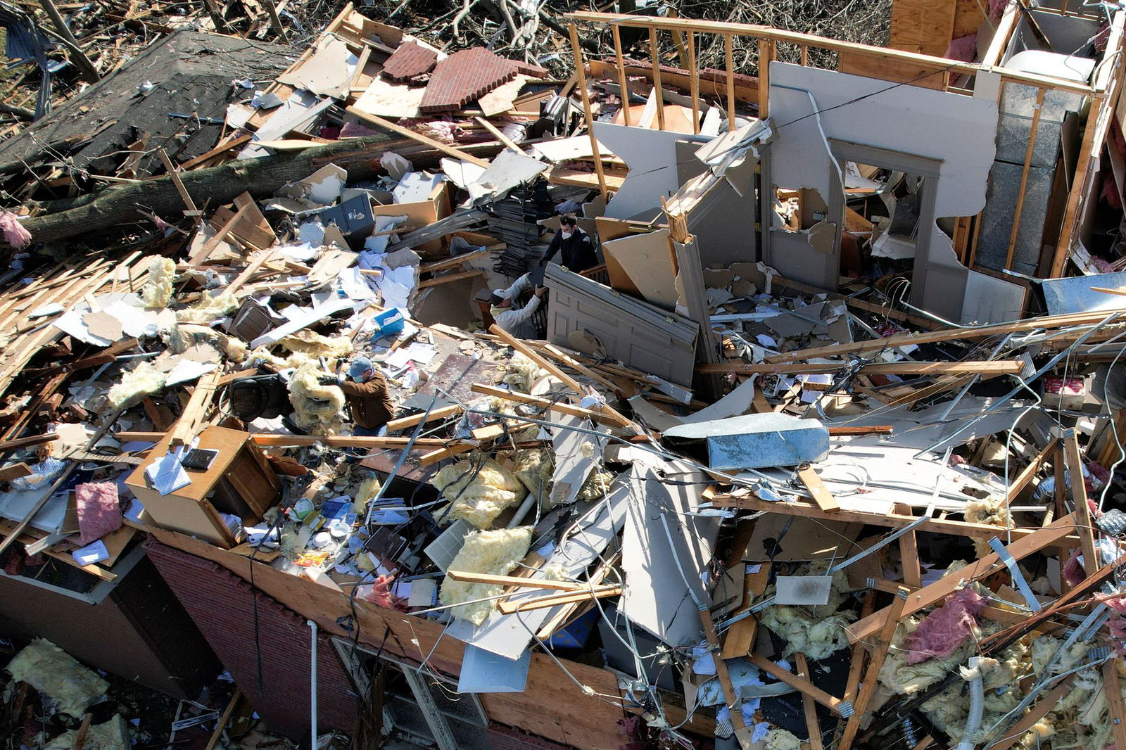 People work inside a destroyed home after devastating outbreak of tornadoes ripped through several U.S. states, in Mayfield, Kentucky, Dec. 11, 2021. Picture taken with a drone.