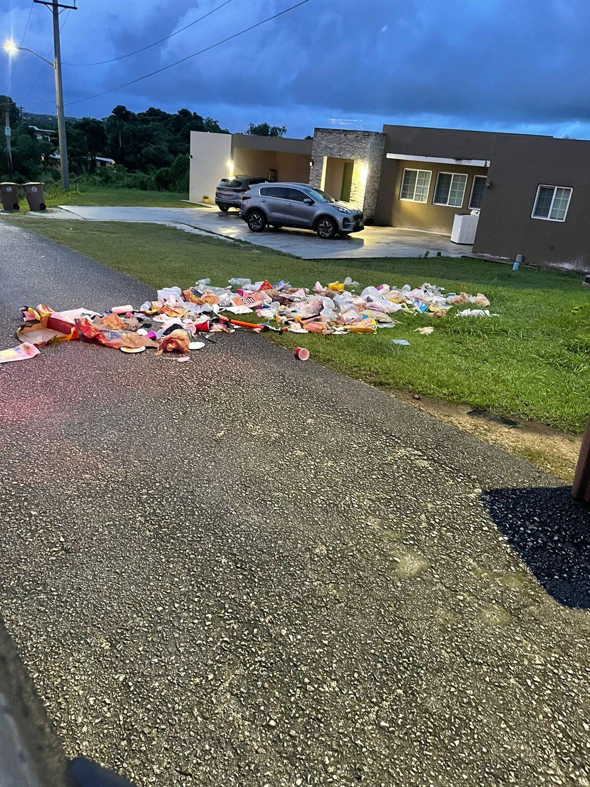 Trash is strewn all over the front yard of a Mongmong residence after a wild pig went through the trash bins during the early morning hours.