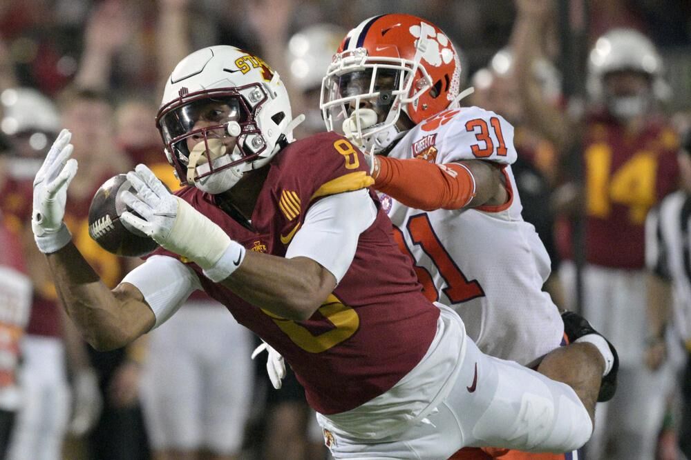 Iowa State wide receiver Xavier Hutchinson (8) catches a 34-yard pass in front of Clemson cornerback Mario Goodrich (31) during the first half of the Cheez-It Bowl NCAA college football game, Wednesday, in Orlando, Fla.