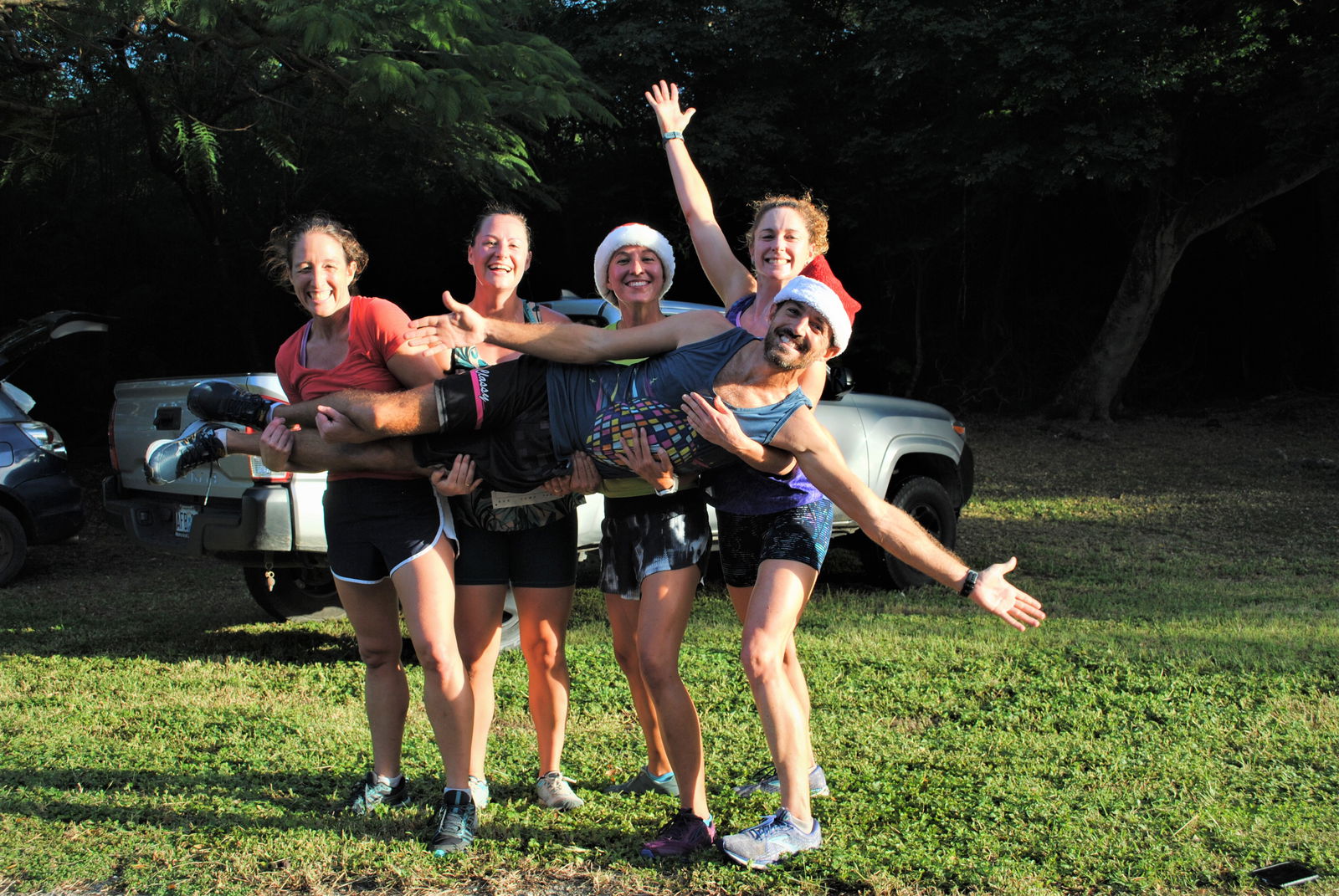 Baby Got Track's Lily Muldoon, Dixie Mendenhall, Kate Wilson and Ali Nelson carry Michael Denevan after topping the 40th Annual Christmas Island Relay Saturday at the Last Command Post in Marpi.