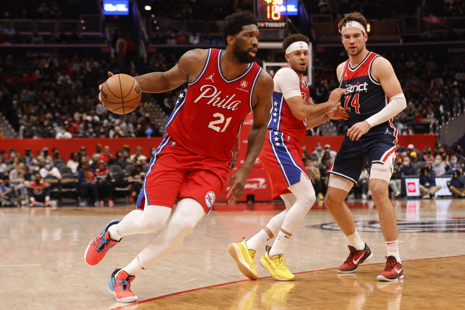 Philadelphia 76ers center Joel Embiid (21) drives to the basket past Washington Wizards forward Corey Kispert (24) during the second quarter at Capital One Arena in Washington, District of Columbia on Dec. 26, 2021.