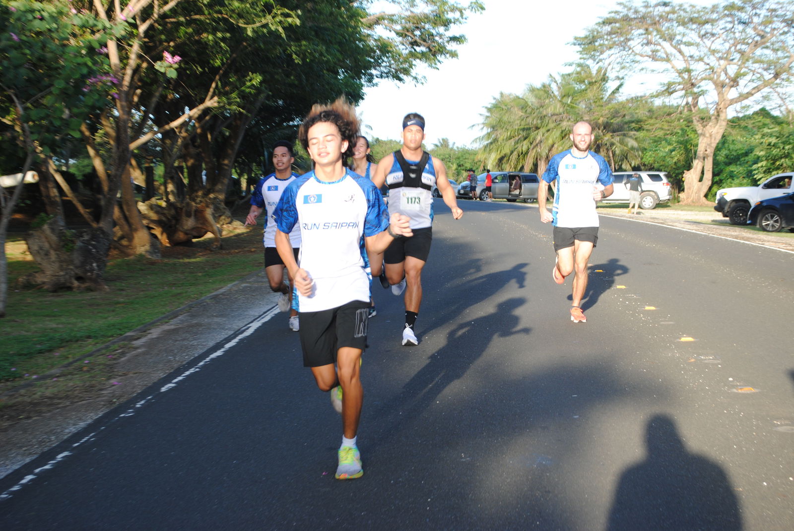 Run Saipan Team A members push through the finish line of the 40th Annual Christmas Island Relay Saturday at the Last Command Post in Marpi.