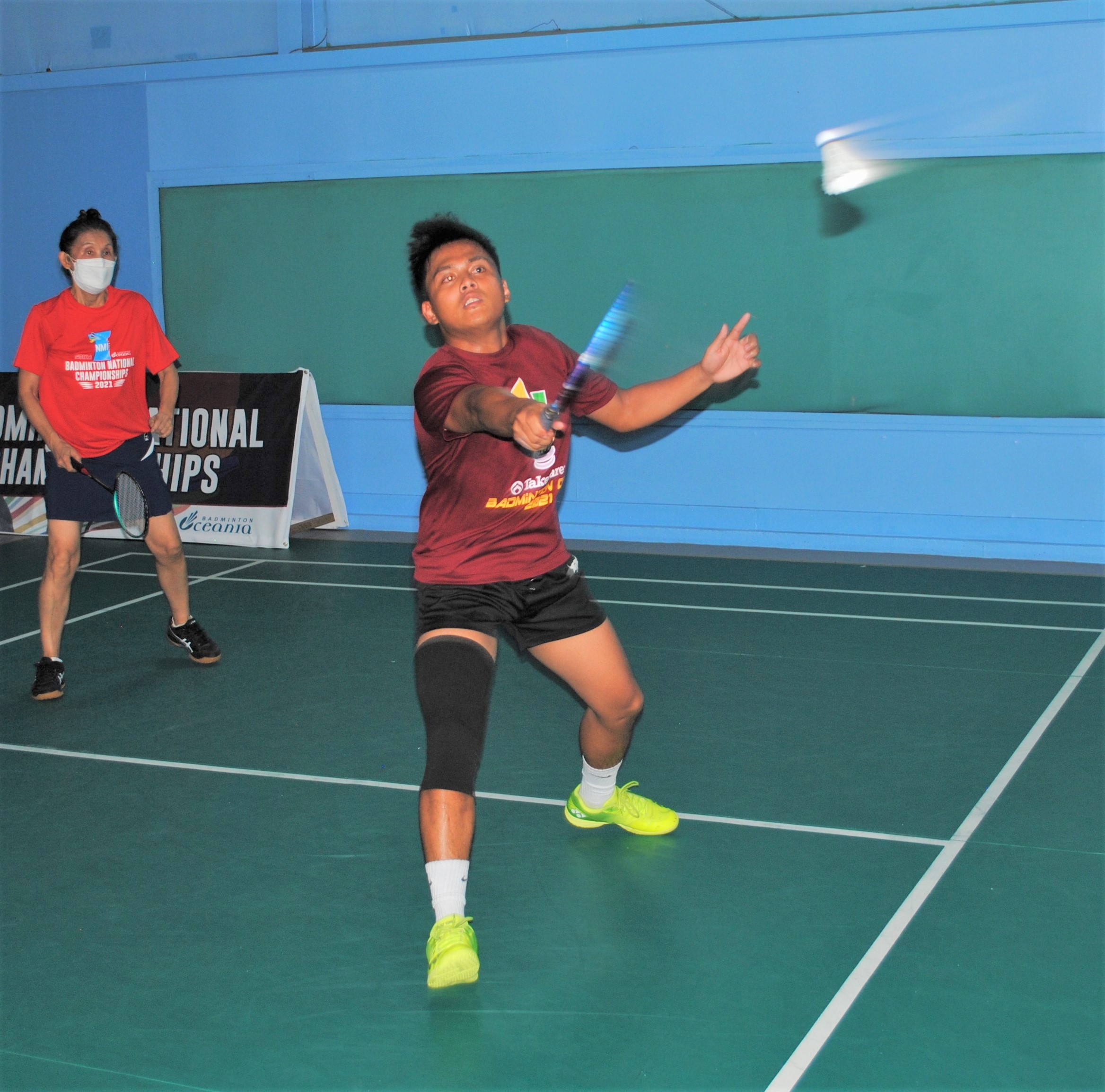 Joseph Torres connects with a return during a national badminton championship match Saturday at the TSL Sports Complex.