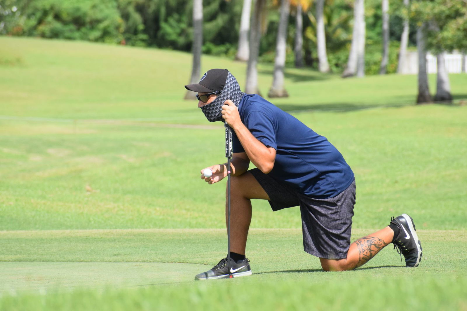 Championship Flight player Dung Tenorio gauges the green on Hole No. 13 before putting.