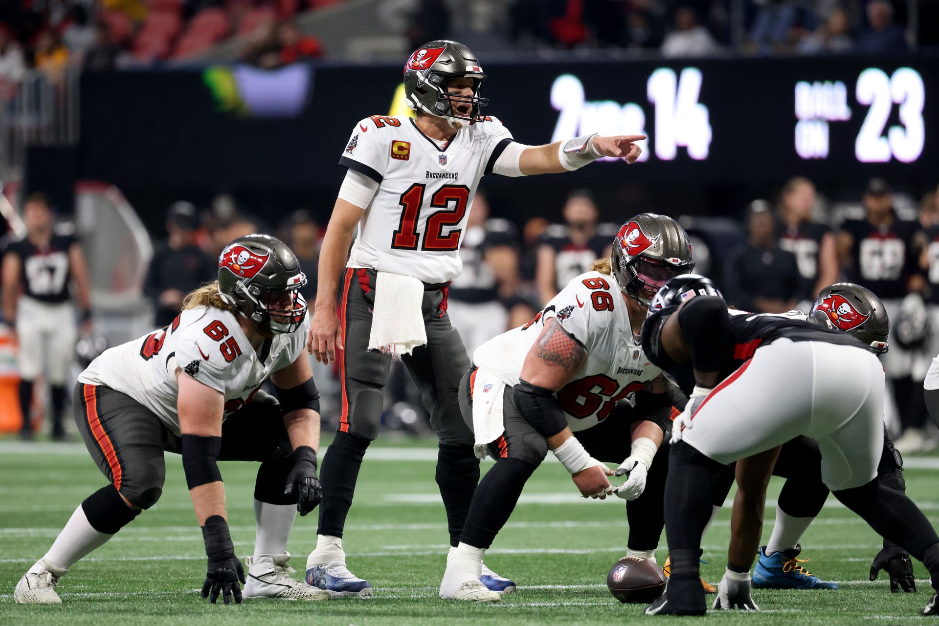 Tampa Bay Buccaneers quarterback Tom Brady (12) makes a pre-snap call as guard Alex Cappa (65) and center Ryan Jensen (66) are shown during the second half against the Atlanta Falcons at Mercedes-Benz Stadium in Atlanta, Georgia on Dec. 5, 2021.