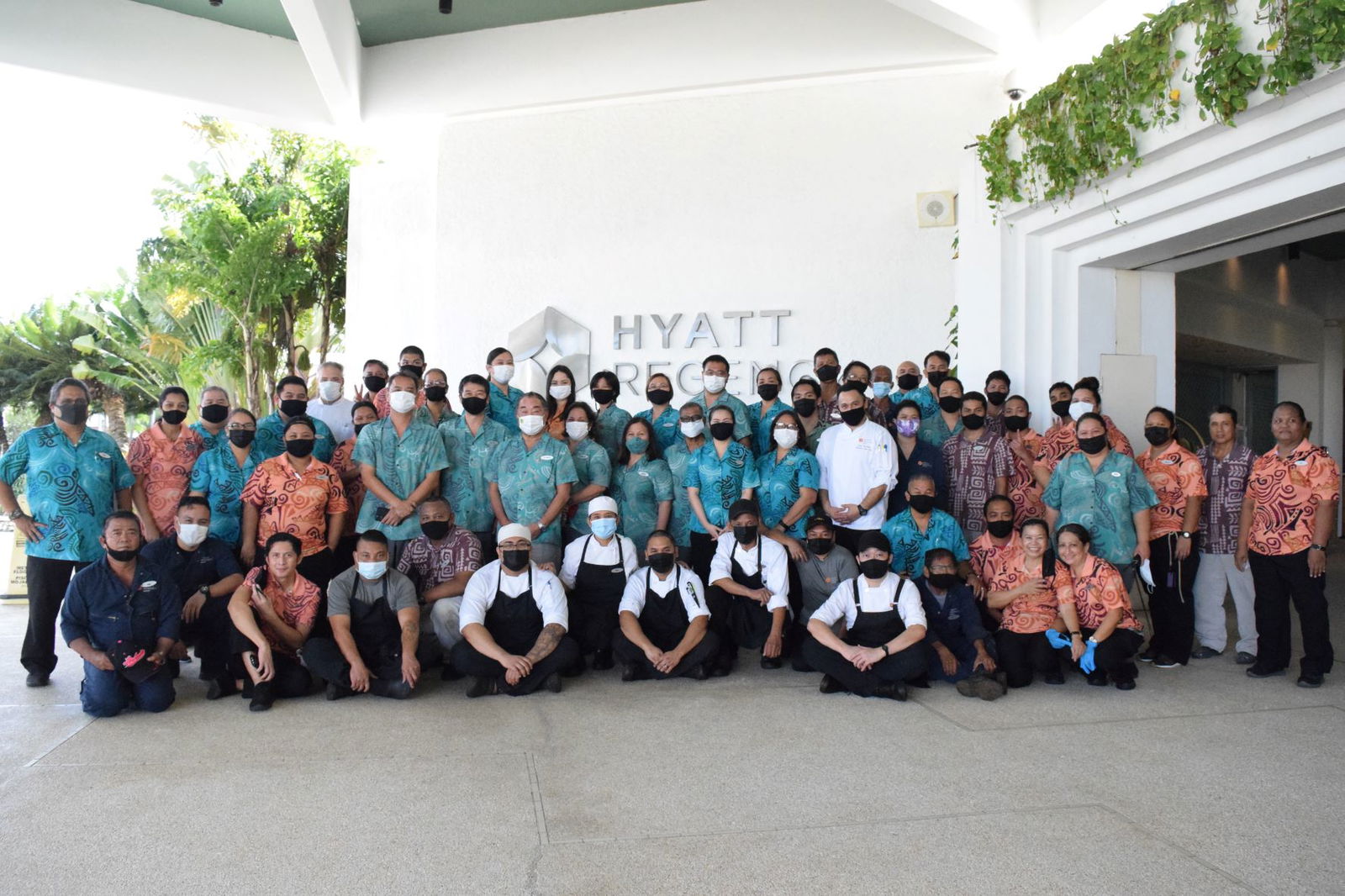 The Hyatt Regency Saipan's management and staff pose for a photo in the hotel lobby.