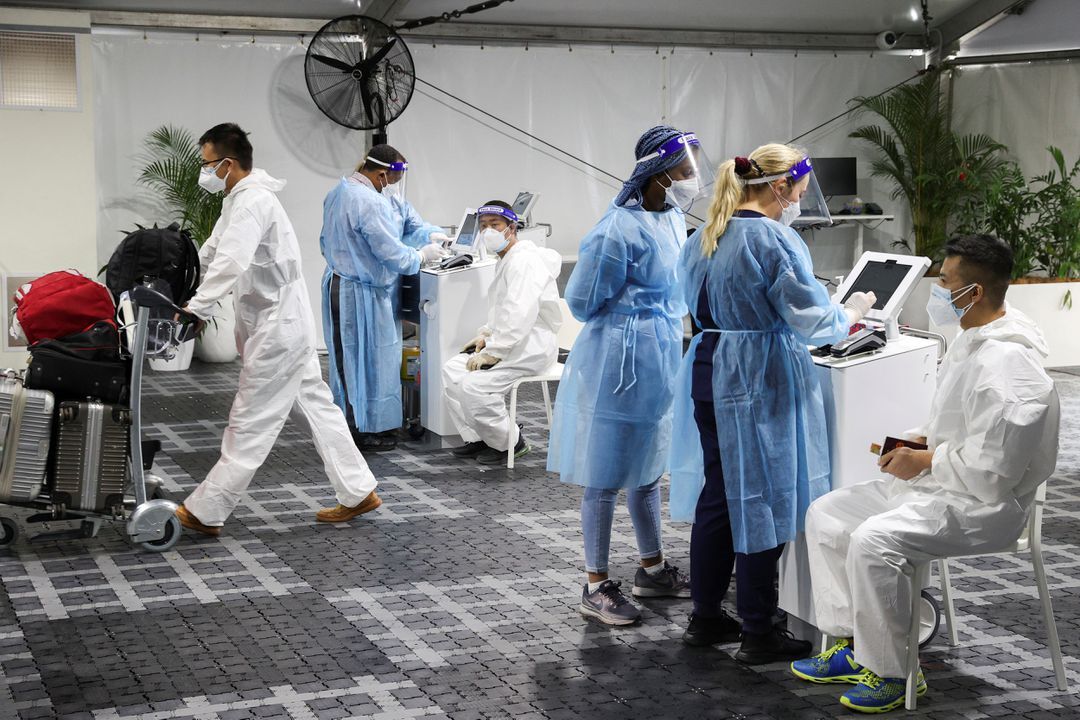 Travelers receive tests for the coronavirus disease at a pre-departure testing facility, as countries react to the new coronavirus Omicron variant, outside the international terminal at Sydney airport in Australia, Nov. 29, 2021.
