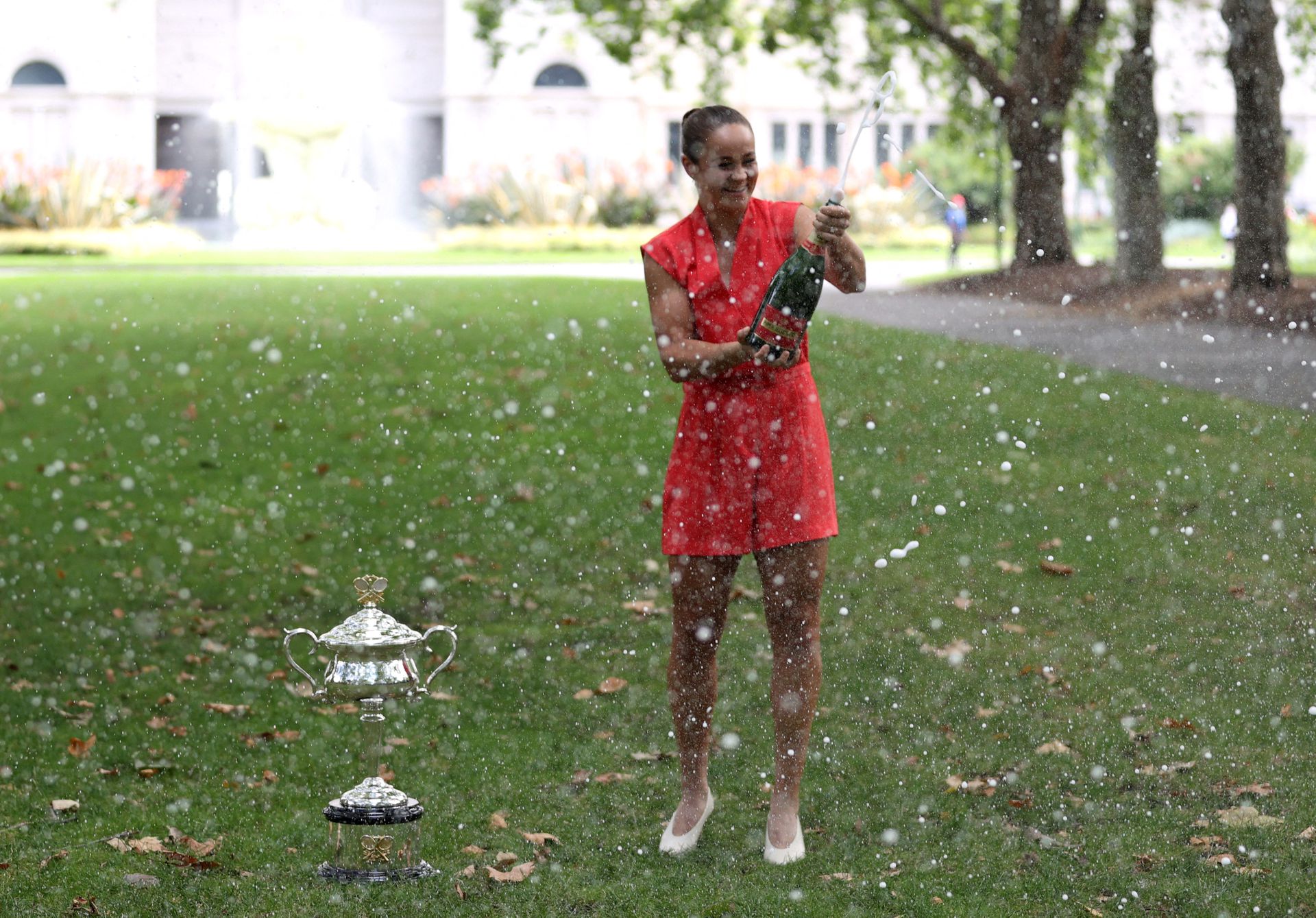 Australian Open champion  Ashleigh Barty sprays champagne during a photo shoot at the Royal Exhibition Building in Melbourne on Jan. 30, 2022.