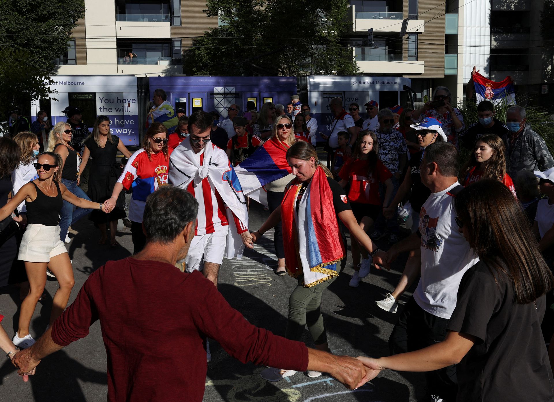 Supporters of Serbian tennis player Novak Djokovic rally outside the Park Hotel, where the star athlete is believed to be held while he stays in Australia, in Melbourne, Australia, Jan. 9, 2022.