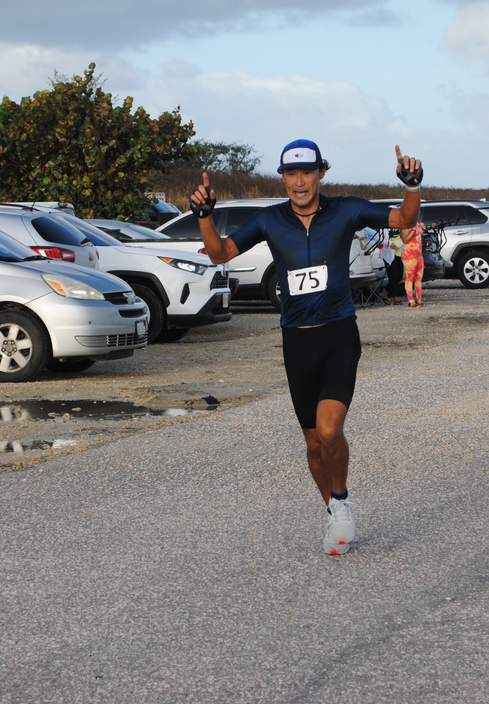 Michiteru Mita celebrates as he crosses the finish line of the 6th Saipan Duathlon in first place, Saturday, at Banzai Cliff.