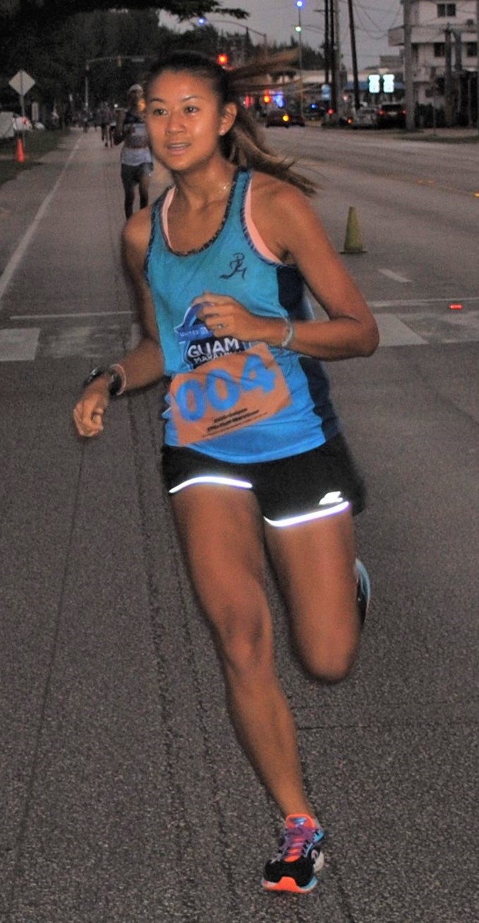 Tania Tan smiles as she crosses the finish line of  Run Saipan’s Run From 2021 race on Beach Road in the Oleai Beach Bar & Grill area.