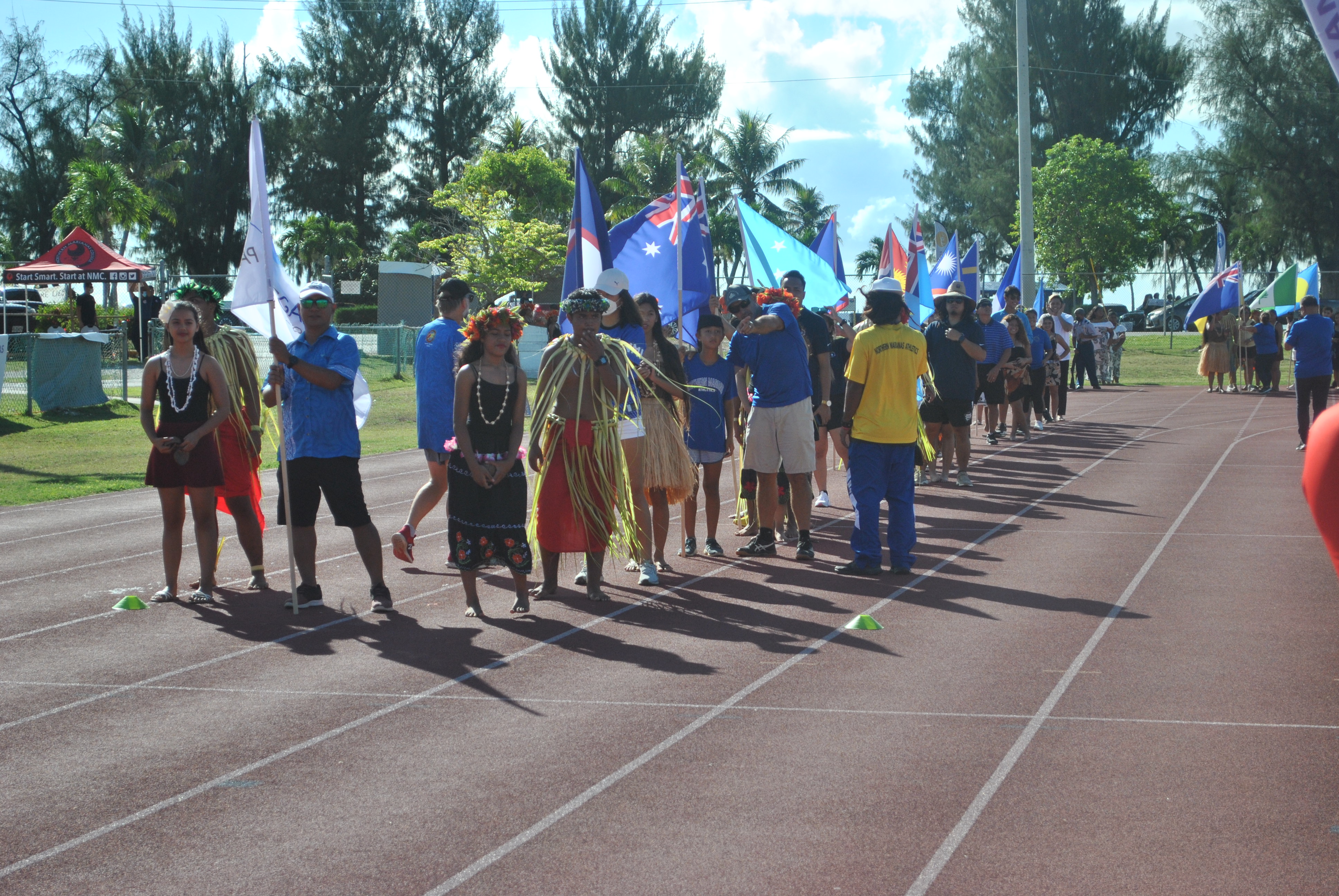 Athletes, sports officials and students get ready to march and present the flags of the 24 participating countries/territories of the 2022 Pacific Mini Games during a launch ceremony at the Oleai Sports Complex on June 17, 2021.