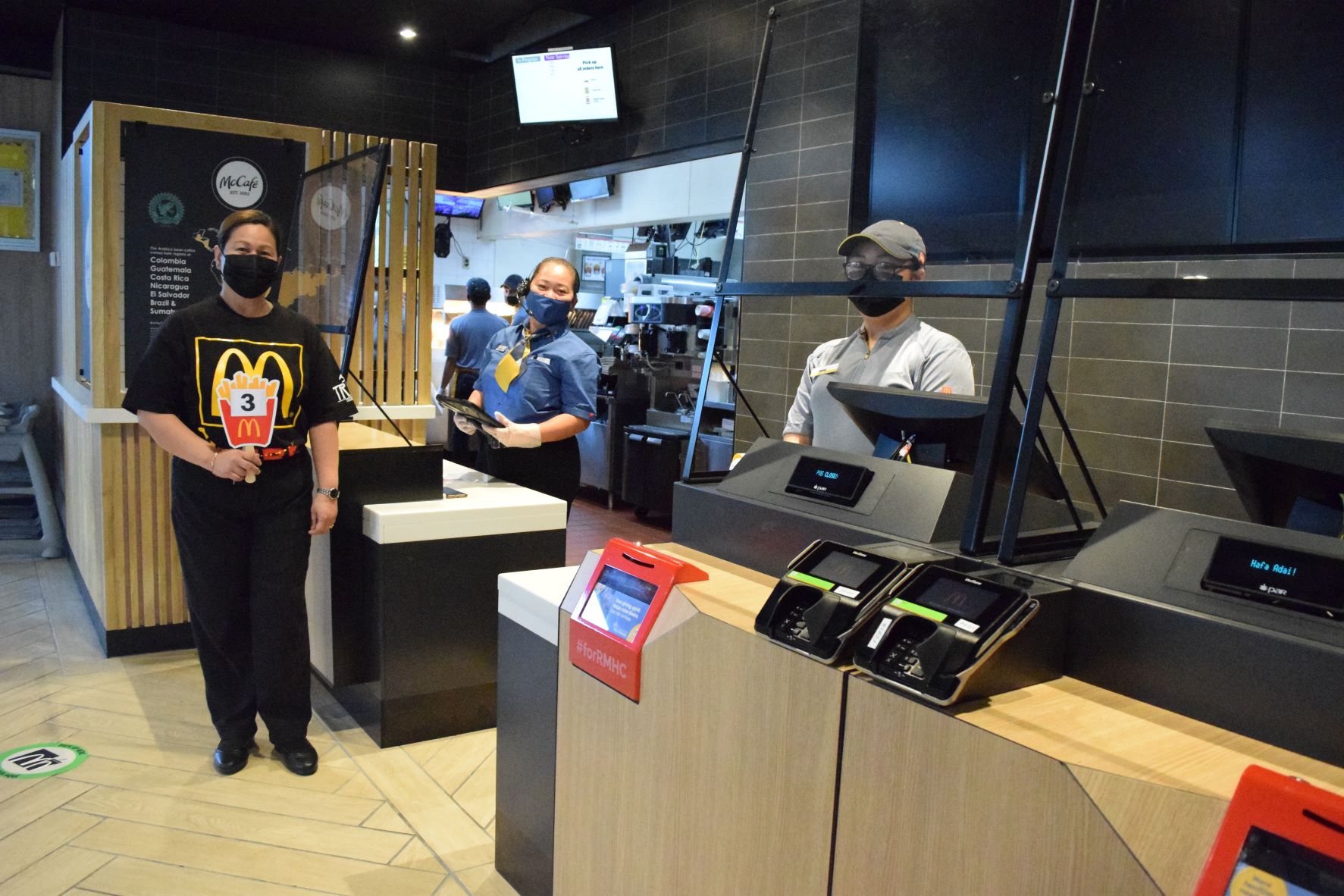 McDonald's Saipan General Manager Jocelyn Asistores, left, Branch Manager Melba Camacho and cashier Edfel Daynos use the new point of sale system for the first time.