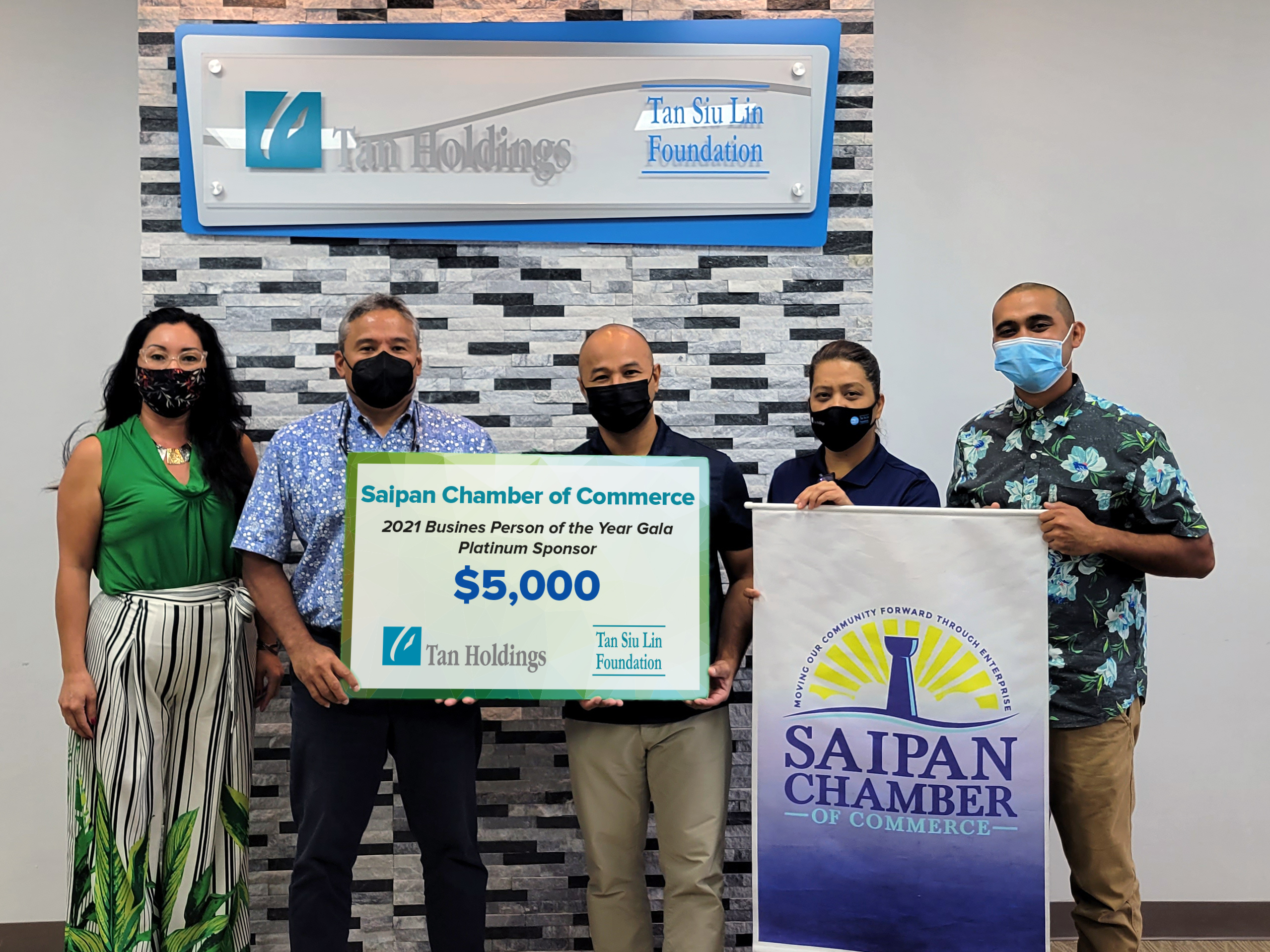 Saipan Chamber of Commerce president Joe Guerrero, center, receives a ceremonial check for the chamber’s Cloaks & Tiaras Business Person of the Year Gala from TanHoldings executive Alex Sablan, second left, Wednesday in the TanHoldings conference room in Garapan. Also in the photo are, from left, chamber secretary Marcia Calvo, TSL Foundation administrative officer Rina Robles, and chamber coordinator Franco Santos.