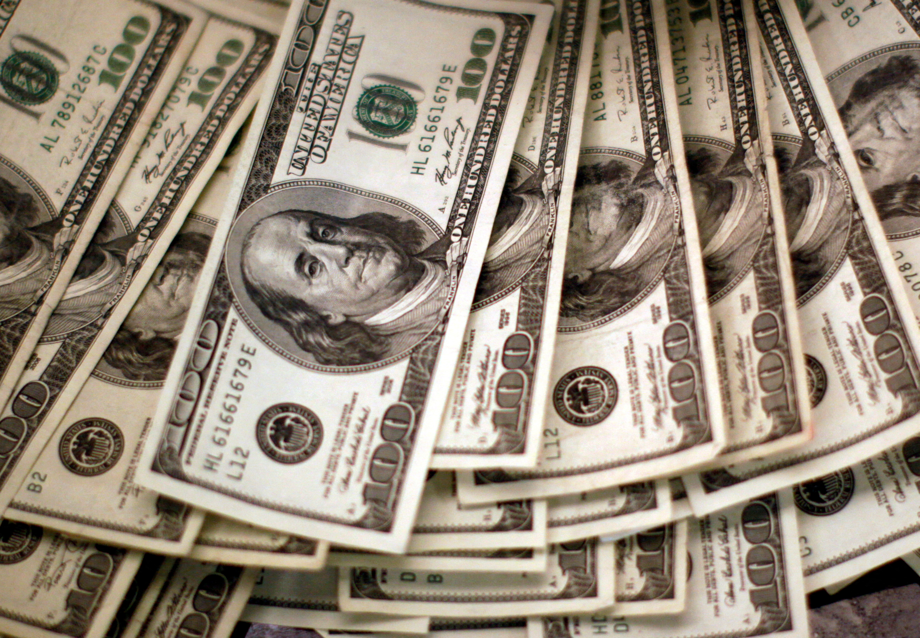 Four thousand U.S. dollars are counted out by a banker counting currency at a bank in Westminster, Colorado on Nov. 3, 2009.