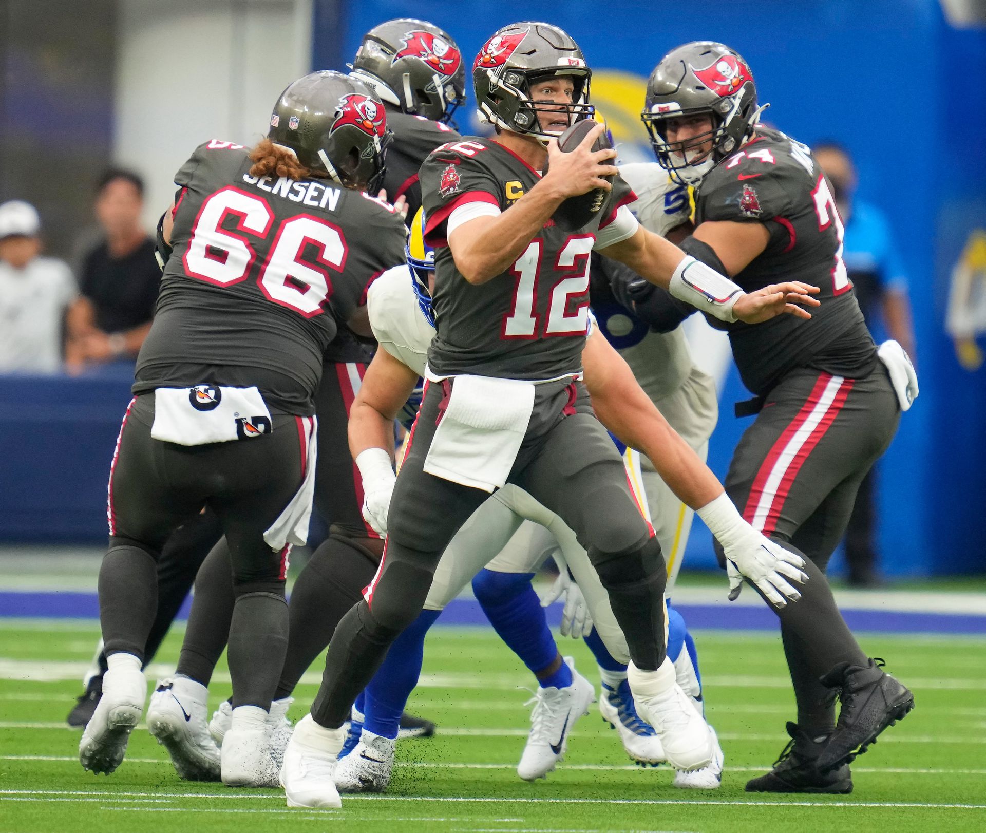 Tampa Bay Buccaneers quarterback Tom Brady (12) is chased out of the pocket in the third quarter at SoFi Stadium in Inglewood, California on Sept. 26, 2021.