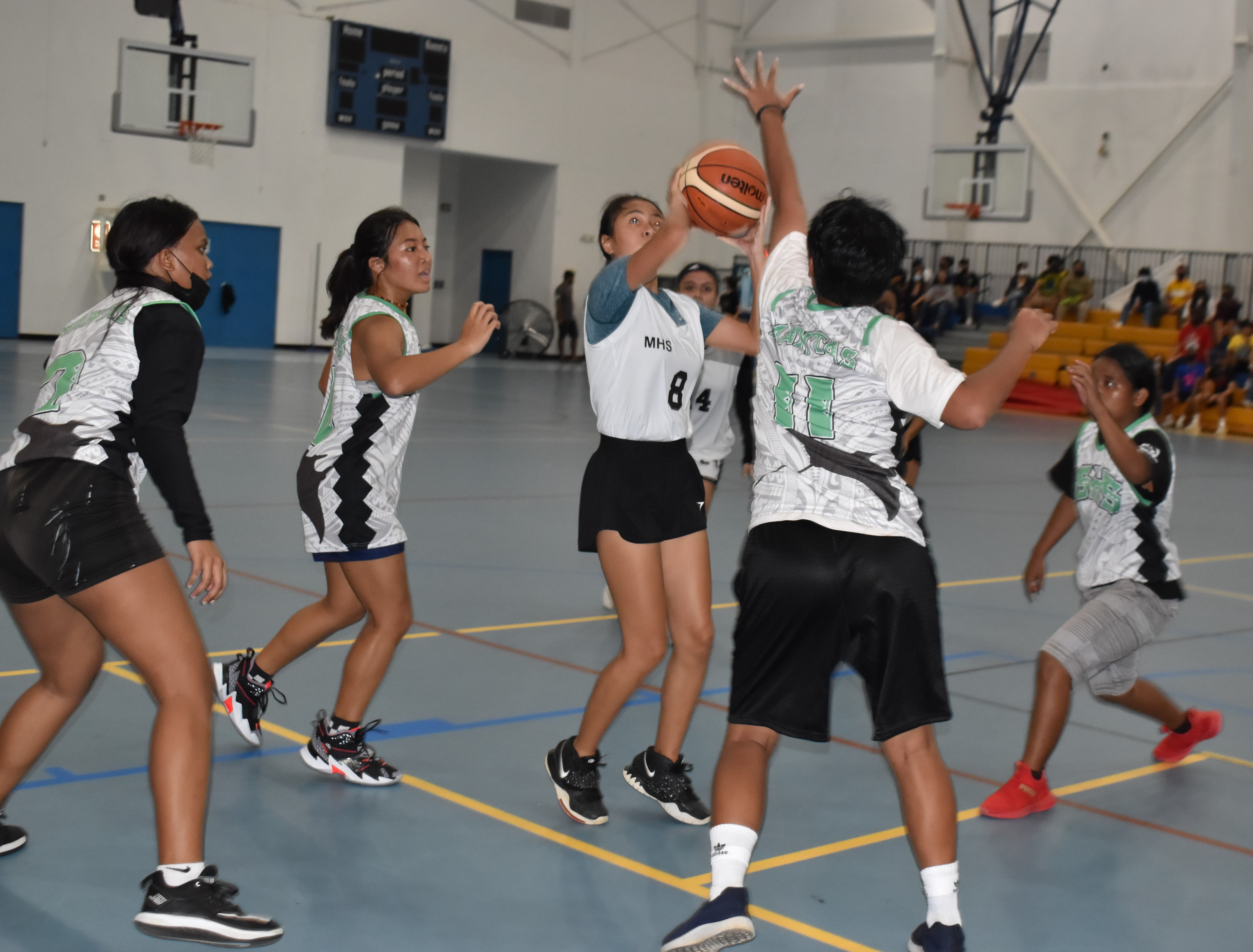 MHS' Marielle Lopez takes the mid-range shot over SSHS defenders during an IT&E Interscholastic Girls High School Basketball League game at the MHS gym Wednesday.