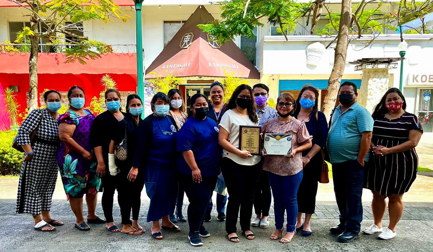 Data Analyst Maggie Reyes, sixth right, poses for a photo with the Office of Vocational Rehabilitation administration and staff members after receiving the agency’s 2021 Employee of the Year Award.
