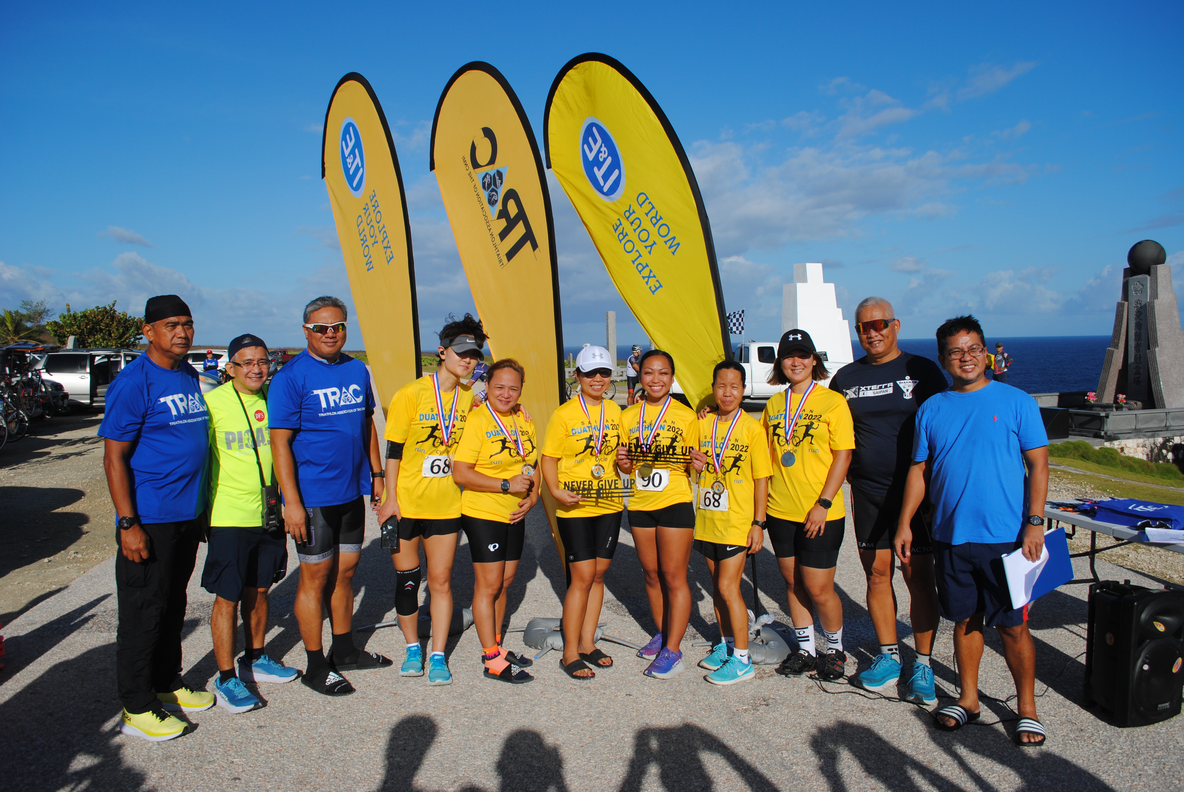 The top three teams in the 6th Saipan Duathlon women's relay pose with  officials of the Triathlon Association of the CNMI during the awards ceremony, Saturday, at Banzai Cliff.