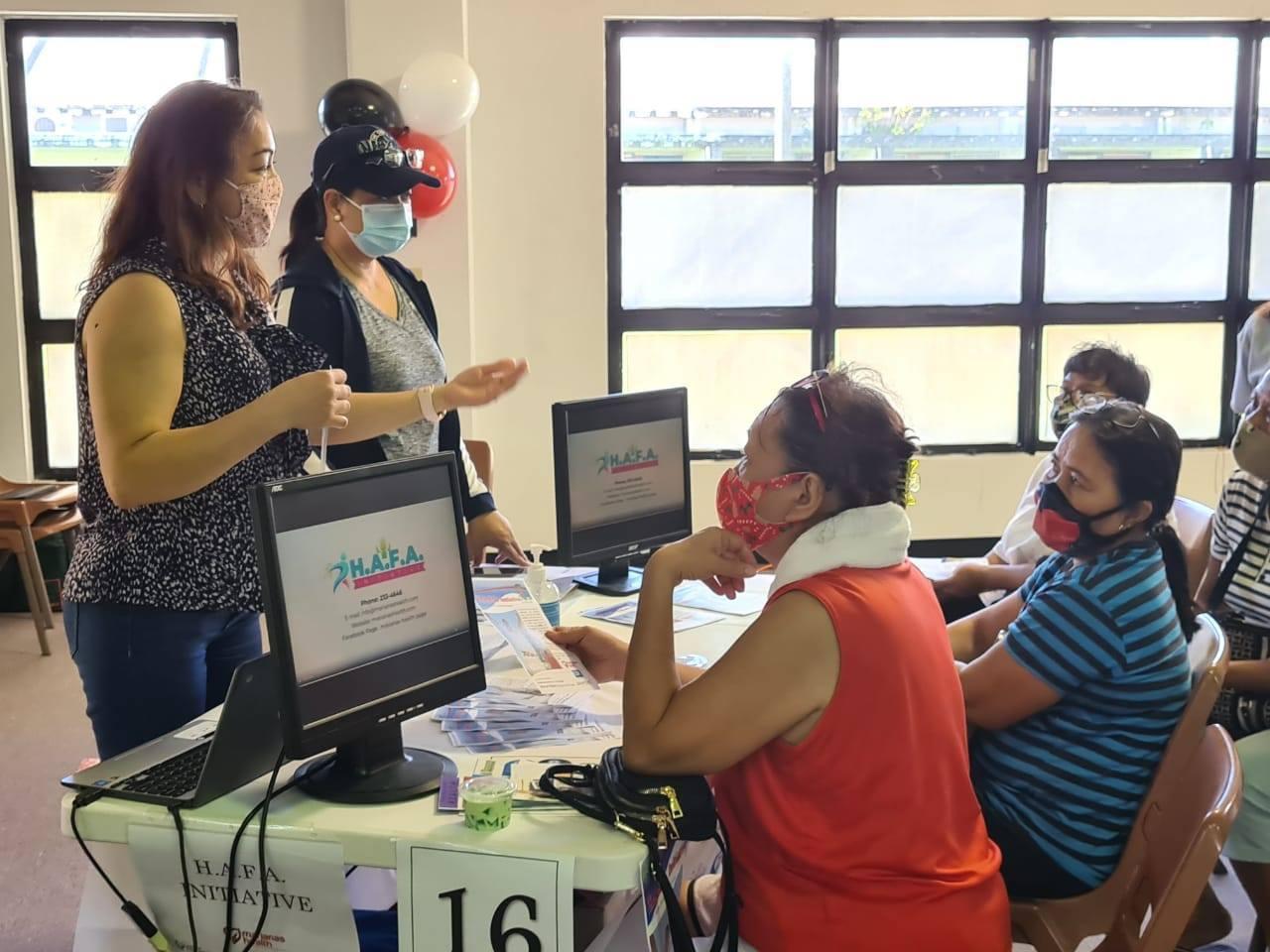 Lifestyle coach Marlene Cruz, left standing, talks about the HAFA Initiative program at the multi-purpose center during the Health and Wellness Expo on Dec. 5, 2020.