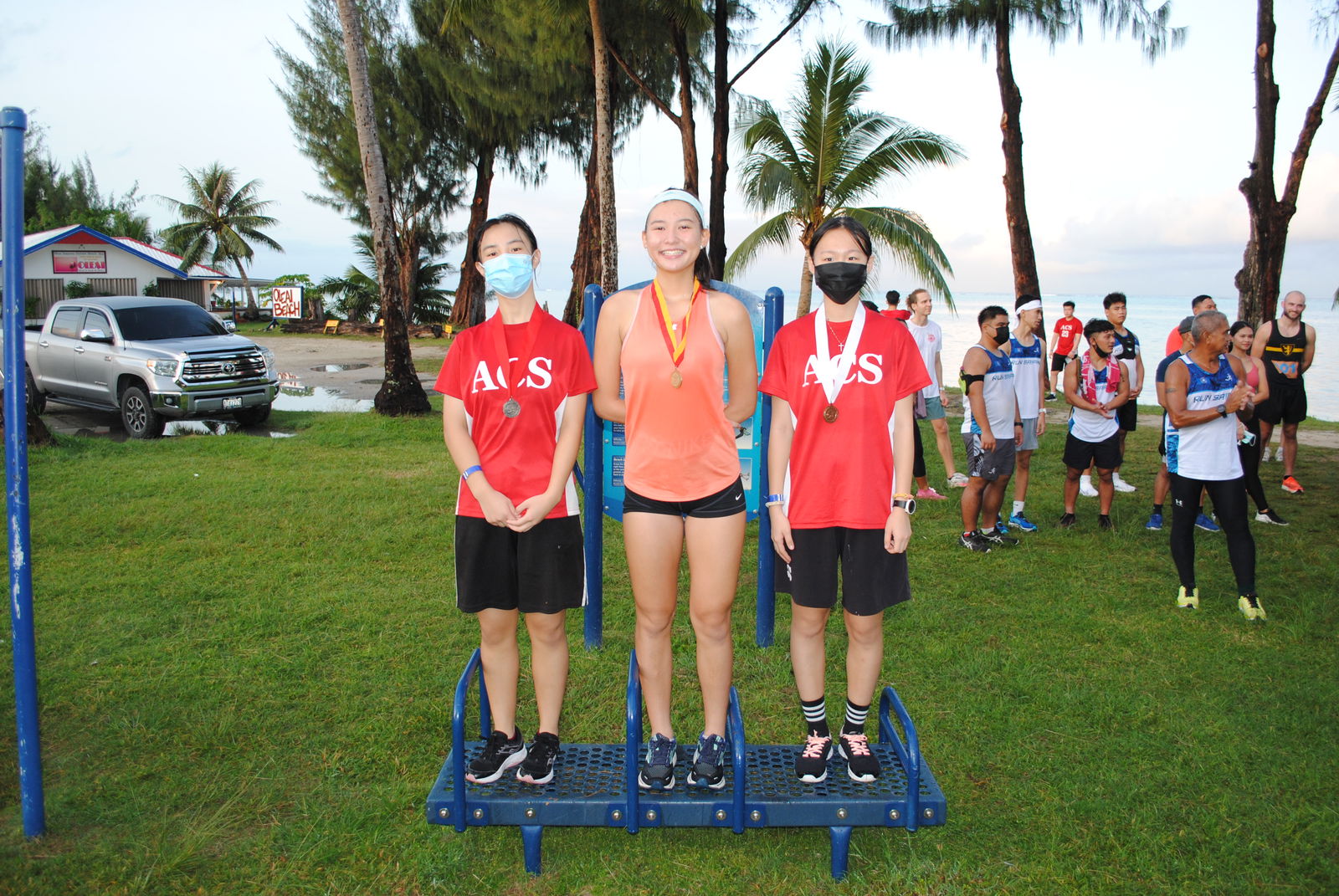 From left, Eunice Xu, Tiana Cabrera and Emma Pang pose for a photo during the awards ceremony of the  Run Saipan’s Run From 2021 one-mile race on Friday.