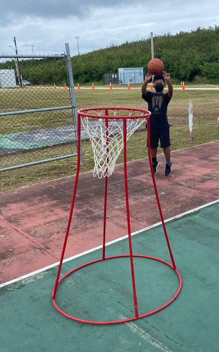 A participant in the “Bola” kick-off session performs shooting drills at the Koblerville Basketball Court on Saturday.