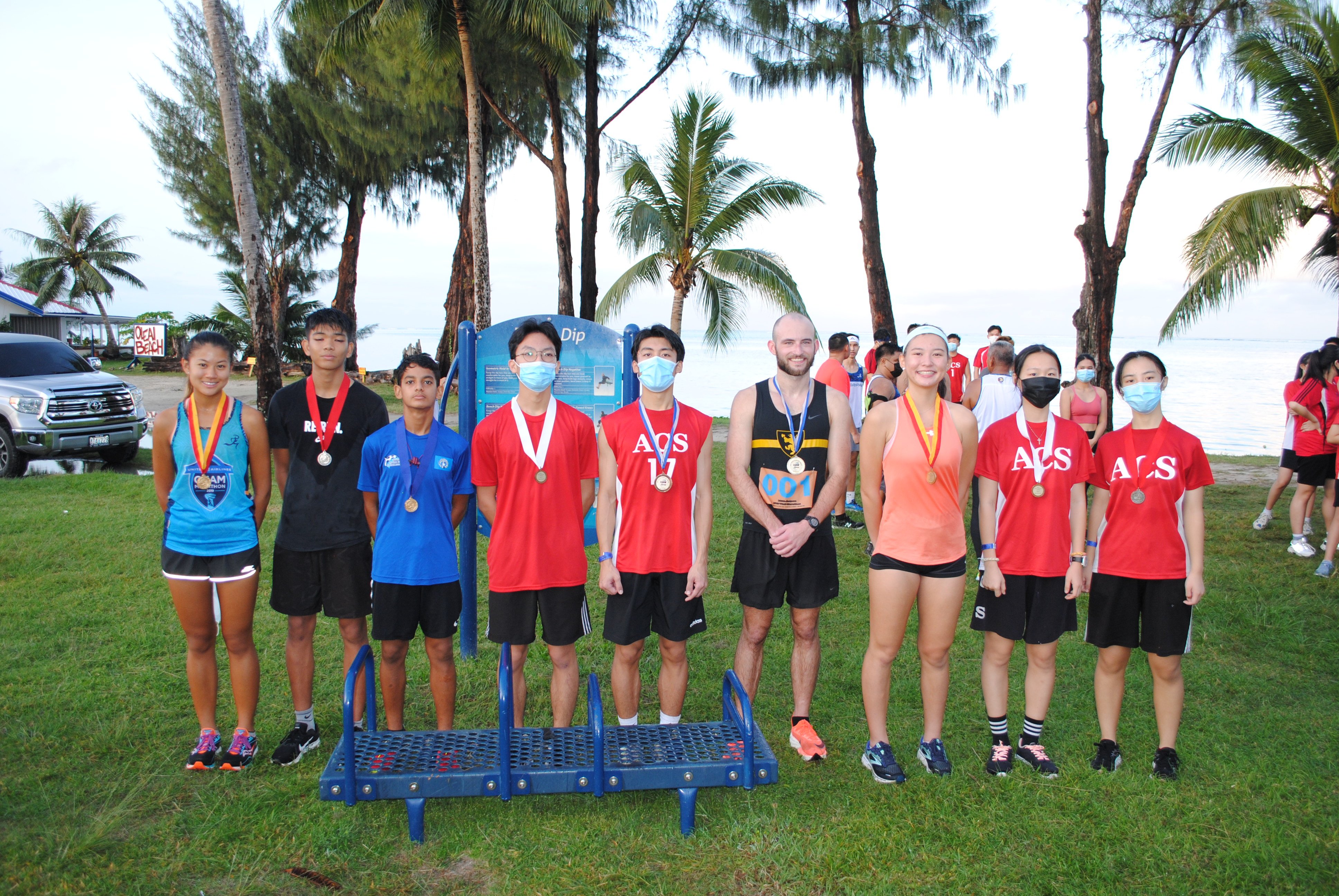 The top three runners of each division pose with their medals during the awards ceremony of  Run Saipan’s Run From 2021 race on Friday on Beach Road in the Oleai Beach Bar & Grill area.