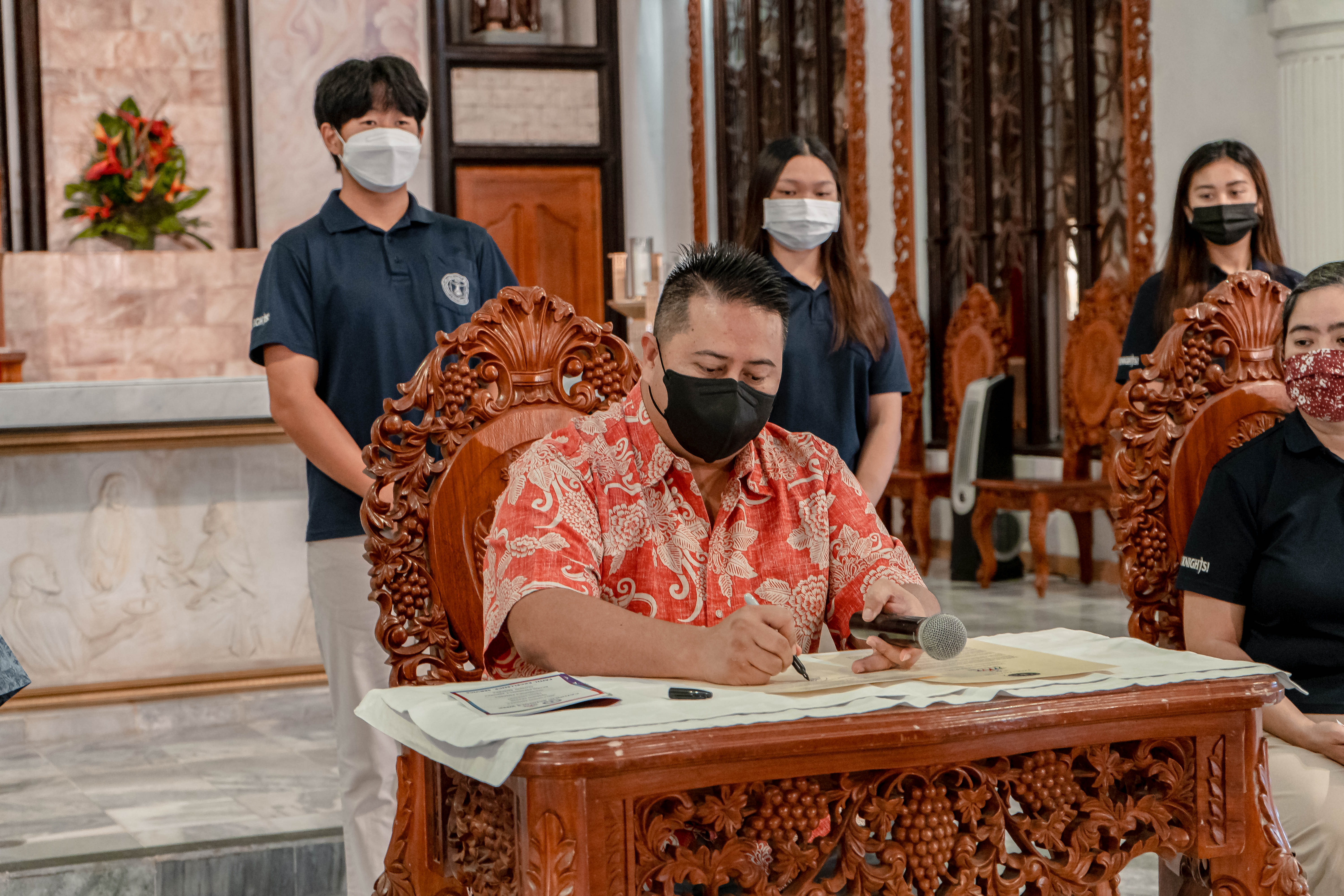 Gov. Ralph DLG Torres signs a proclamation designating Jan. 30 – Feb. 5, 2022 as Catholic Schools Week at the Mount Carmel Cathedral on Wednesday.