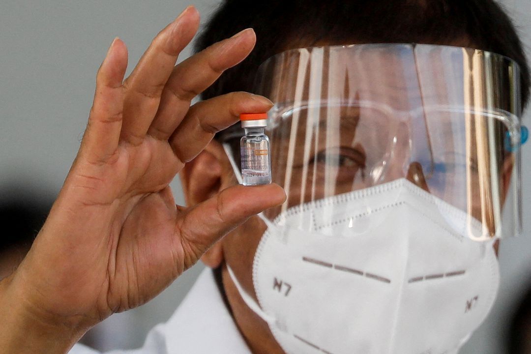Philippine President Rodrigo Duterte holds a vial of Sinovac Biotech's CoronaVac as the first shipment of coronavirus disease vaccine arrives in the country, at Villamor Air Base, Pasay, Metro Manila on Feb. 28, 2021.