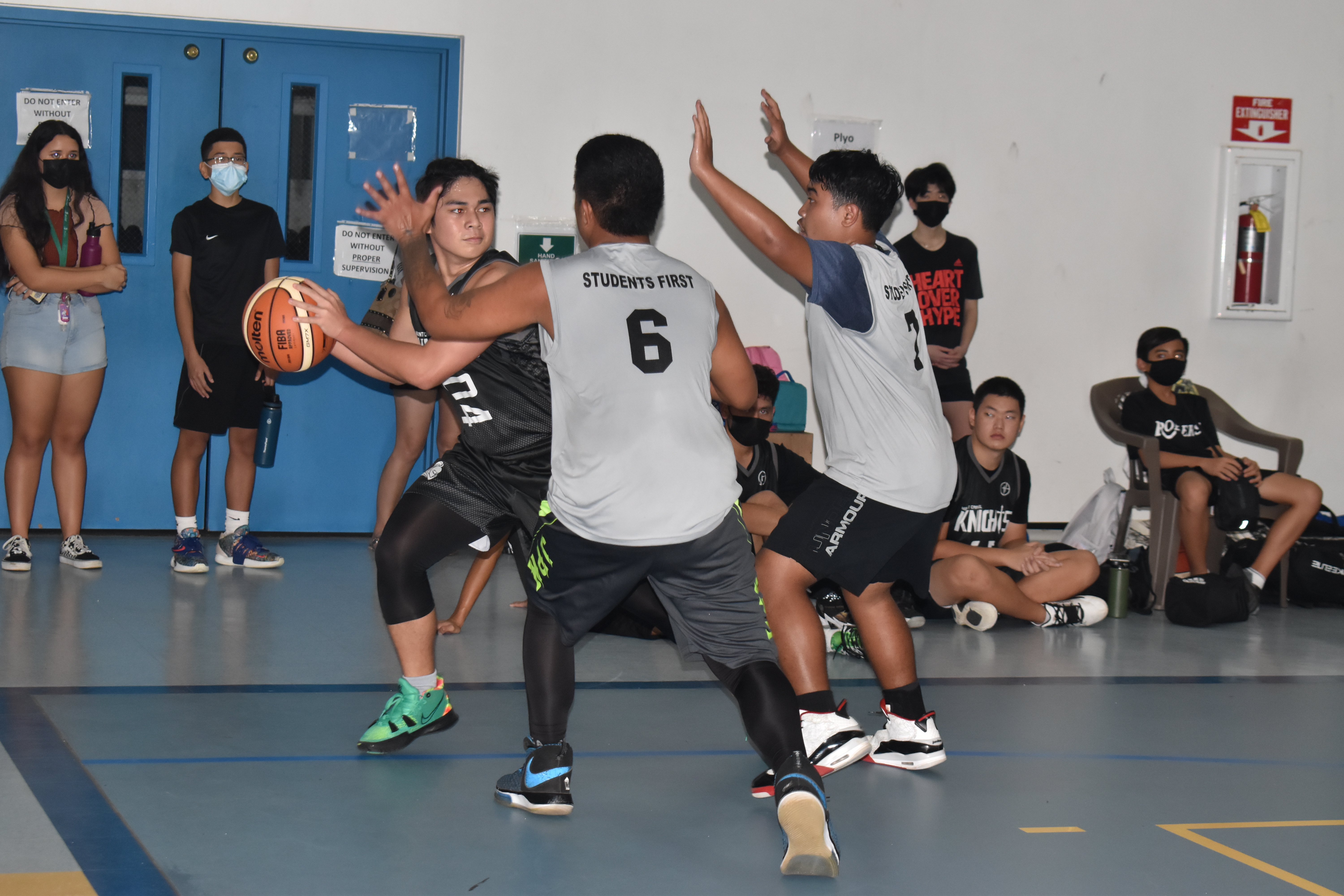 Two Da'ok defenders trap a MCS V player as he protects the ball during an IT&E Interscholastic Boys High School Basketball League game Friday at the MHS gym.