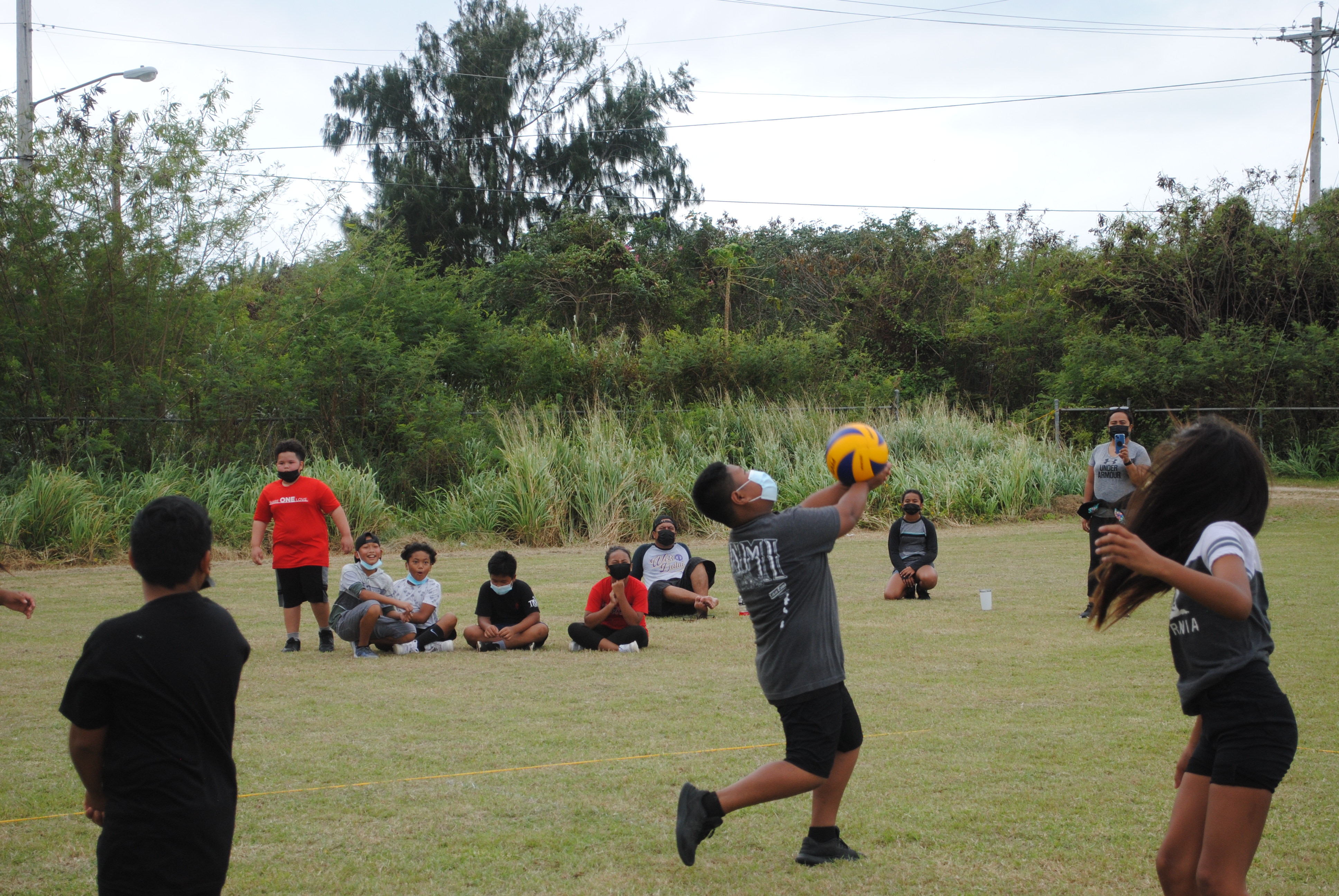 A Koblerville Elementary School 1 player stretches for the save during a co-ed volleyball game at the Chacha Oceanview Middle School field on Saturday.