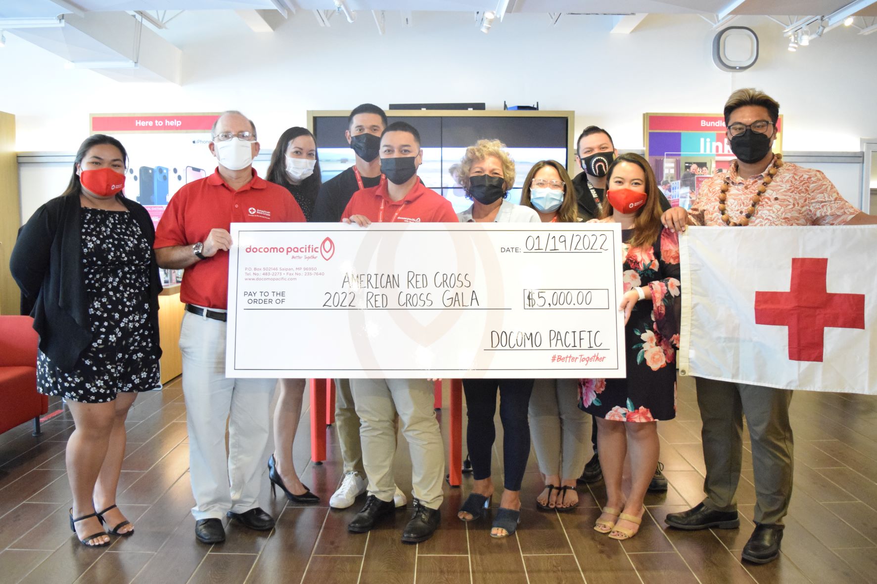 Docomo Pacific Saipan general manager Pauline Johnson, fifth right, and brand manager Brent Deleon Guerrero, center, hold a ceremonial check with American Red Cross-NMI chapter executive director John Hirsh, second left, at the Docomo Pacific Saipan office in Gualo Rai on Wednesday.  Also in photo are American Red Cross-NMI chapter operations coordinator, Selmalyn Taitano, Docomo customer service relations lead Shane Deleon Guerrero, Docomo consumer manager Nicole Babauta, retail manager Conrad Sablan, American Red Cross-NMI chapter board chair Mable Ayuyu-Glenn and vice chair Dr. Bobby Cruz.