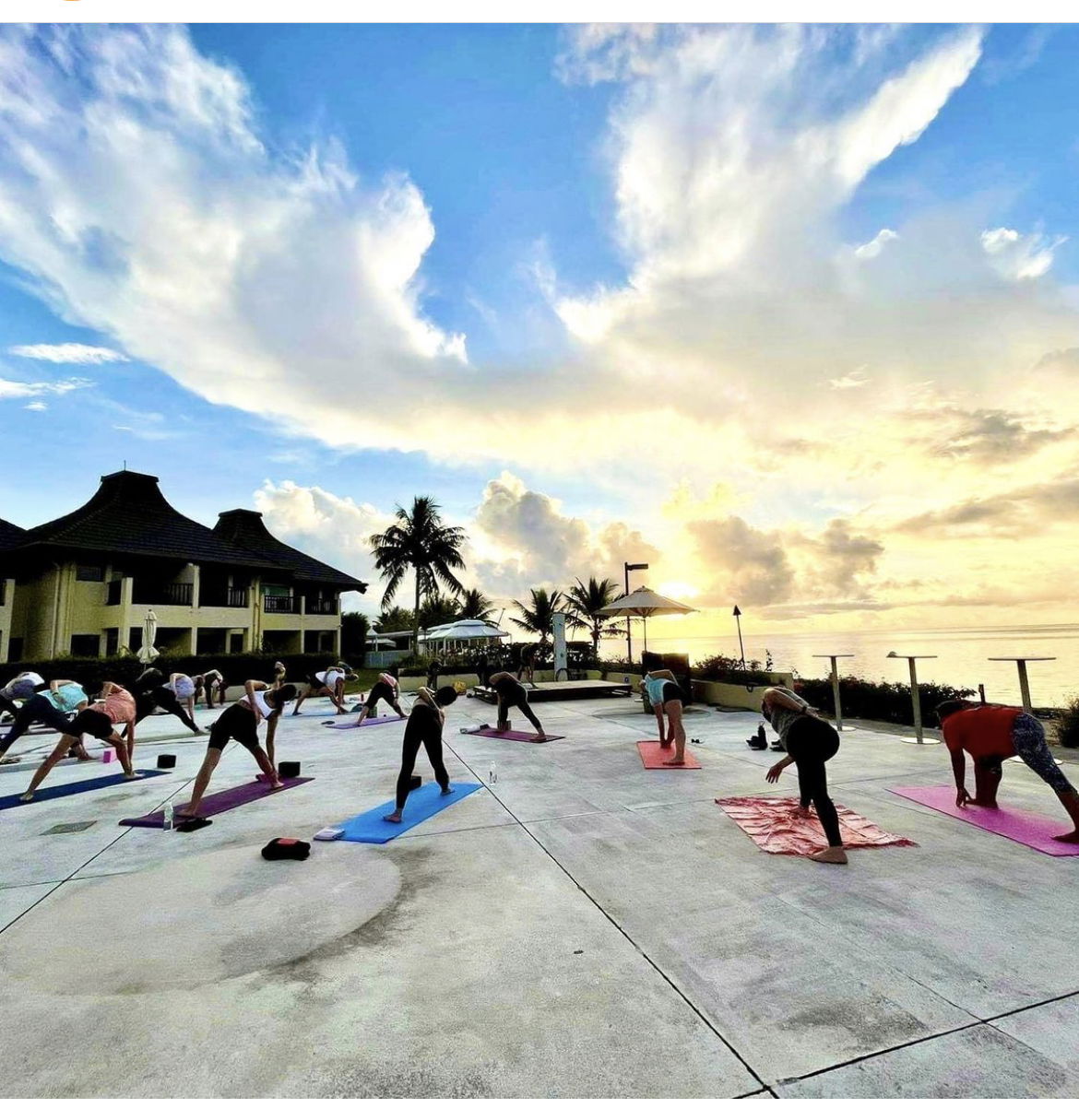 Class participants perform a yoga pose.