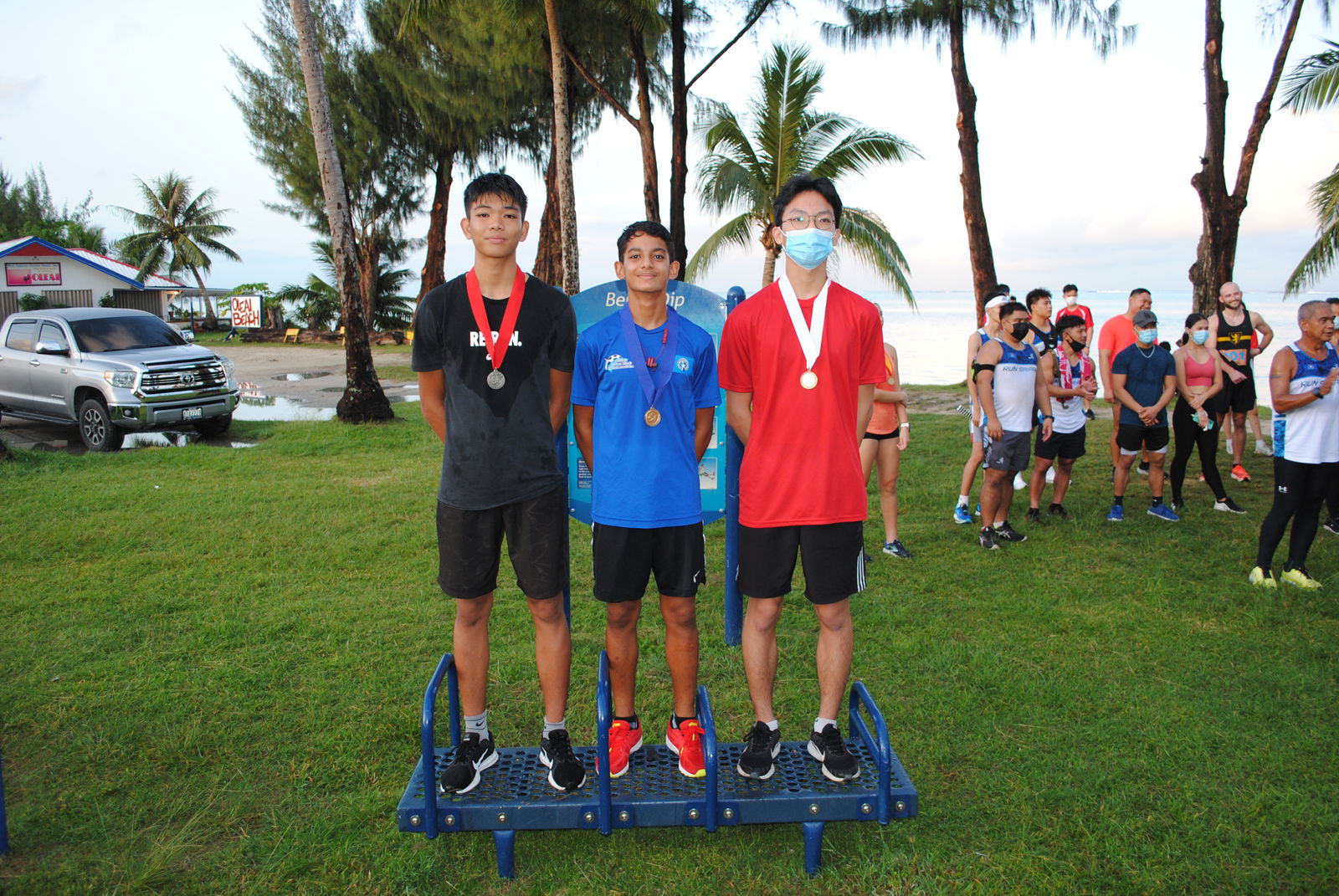 From left, Cody Shimizu, Dev Bachani and Jason Cao pose for a photo during the awards ceremony of the  Run Saipan’s Run From 2021 one-mile race on Friday.